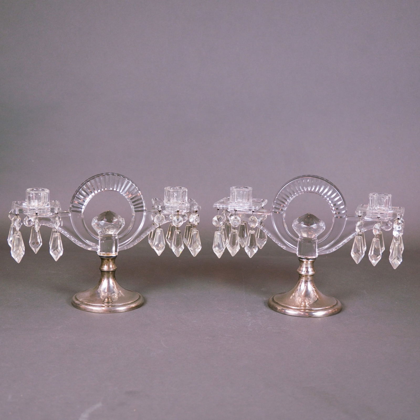 Pair of Heisey Crystal and Hawkes Sterling Silver Candelabras: This fine pair of vintage Art Deco candelabras represents a sophisticated collaboration between two premier American manufacturers of the early 20th century. Featuring a striking central circular ring