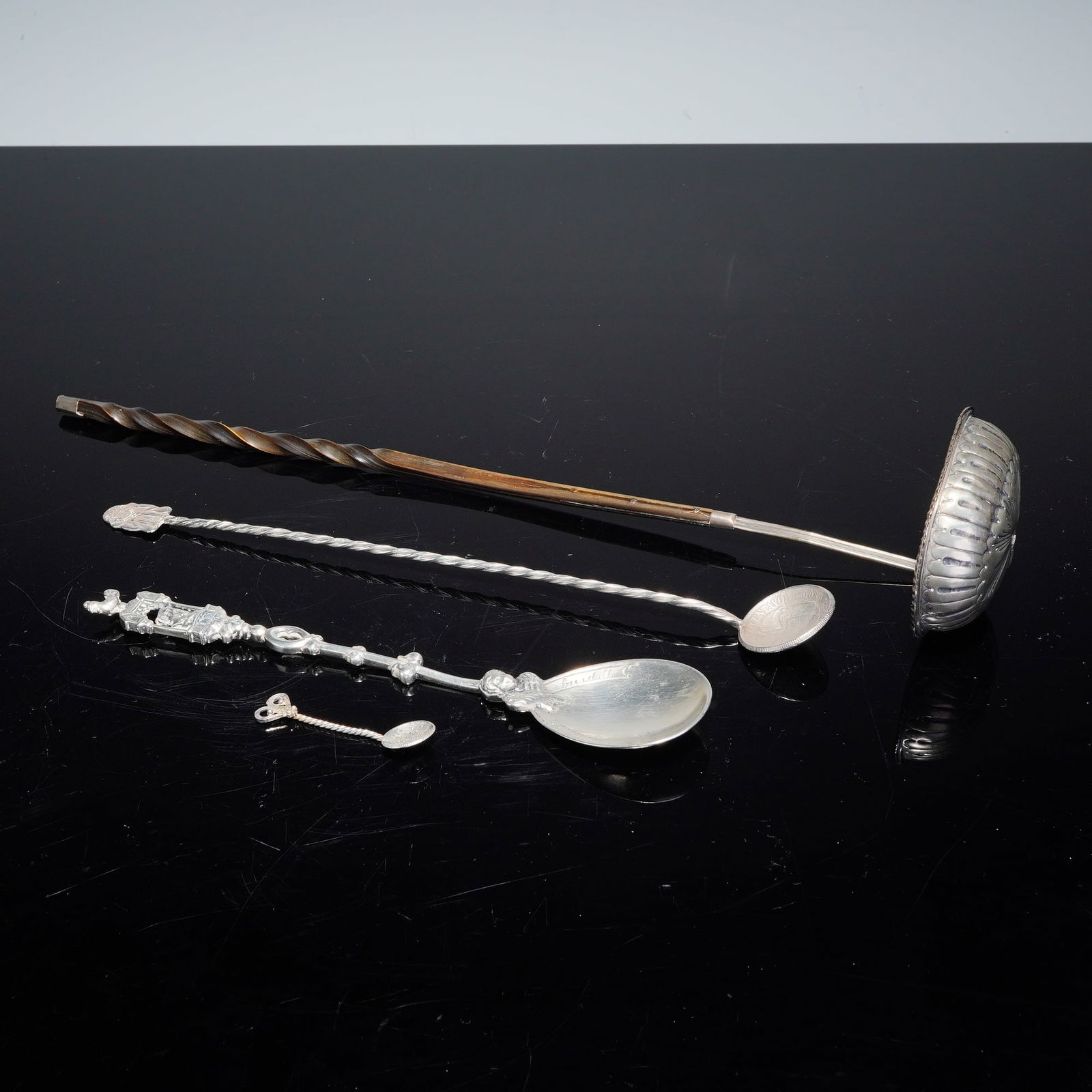 4pc Silver-Plated Spoons and Ladle: A lot of four silver-plated spoons of various styles and periods. The collection includes a Georgian-period ladle featuring a fluted bowl with a beaded rim and a silver connector engraved B Richardson