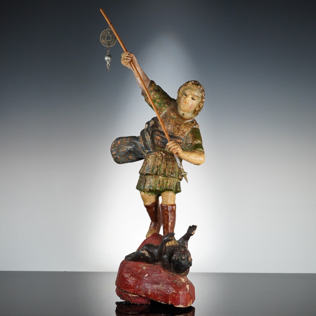 Spanish School, 17th Century, Saint Michael the Archangel: This polychrome carved wood figure of Saint Michael the Archangel is attributed to the Spanish School of the 17th century, exhibiting provincial colonial stylistic elements. The figure is portrayed st