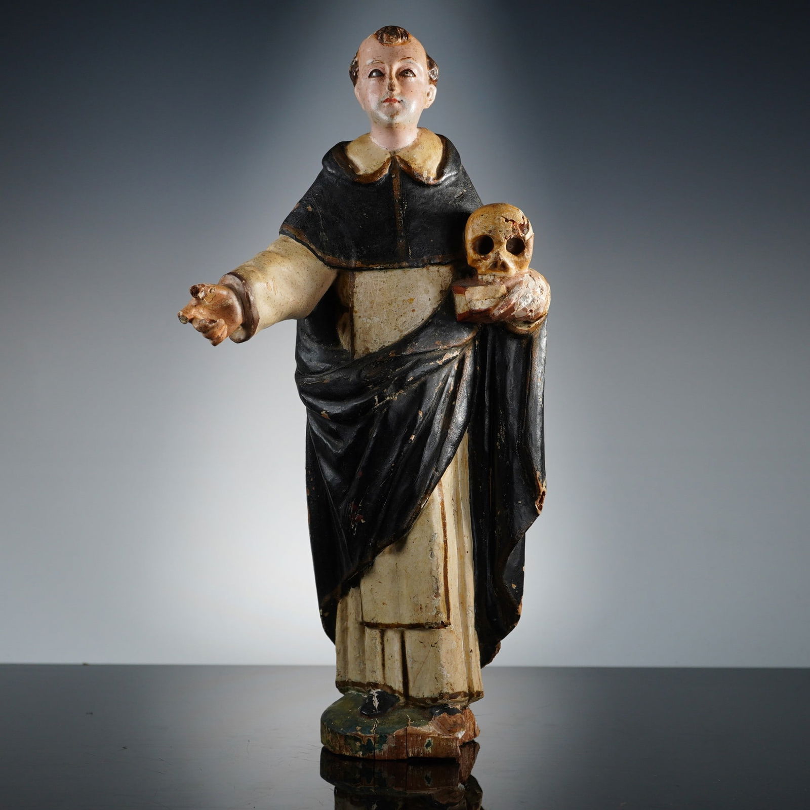 Spanish Colonial Carved and Polychrome Wood Santo of Saint Dominic: A Spanish Colonial carved and polychrome wood santo figure representing Saint Dominic of Guzman. This wooden Spanish saint painted wooden figurine is carved in wood and painted in tempera over a gesso
