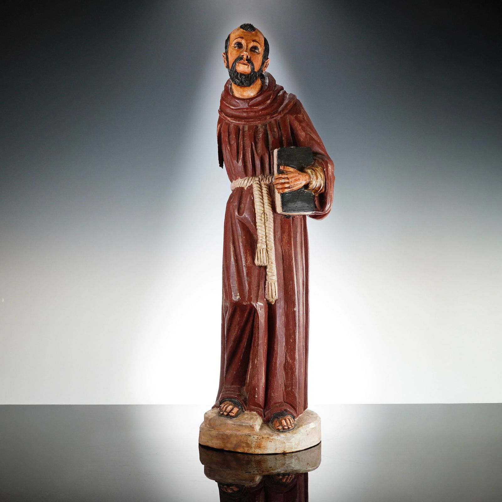 Latin American Carved Polychrome Wood Statue, Saint Francis of Assisi: This Catholic carved devotional imaginary figure of Saint Francis of Assisi is of Latin American origin and dates to the late 20th century. The figure is hand-carved from wood and features a polychrom
