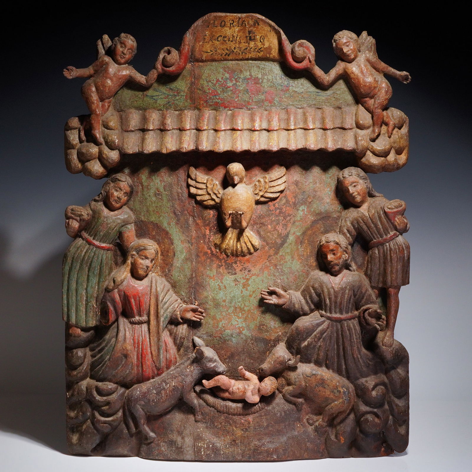 16th Century Spanish Colonial Carved Wood Nativity Scene: A 16th-century Spanish Colonial carved wood relief panel depicting the Nativity of Christ with Mary and Joseph. The central composition features the infant Christ in a manger, flanked by the Virgin Ma