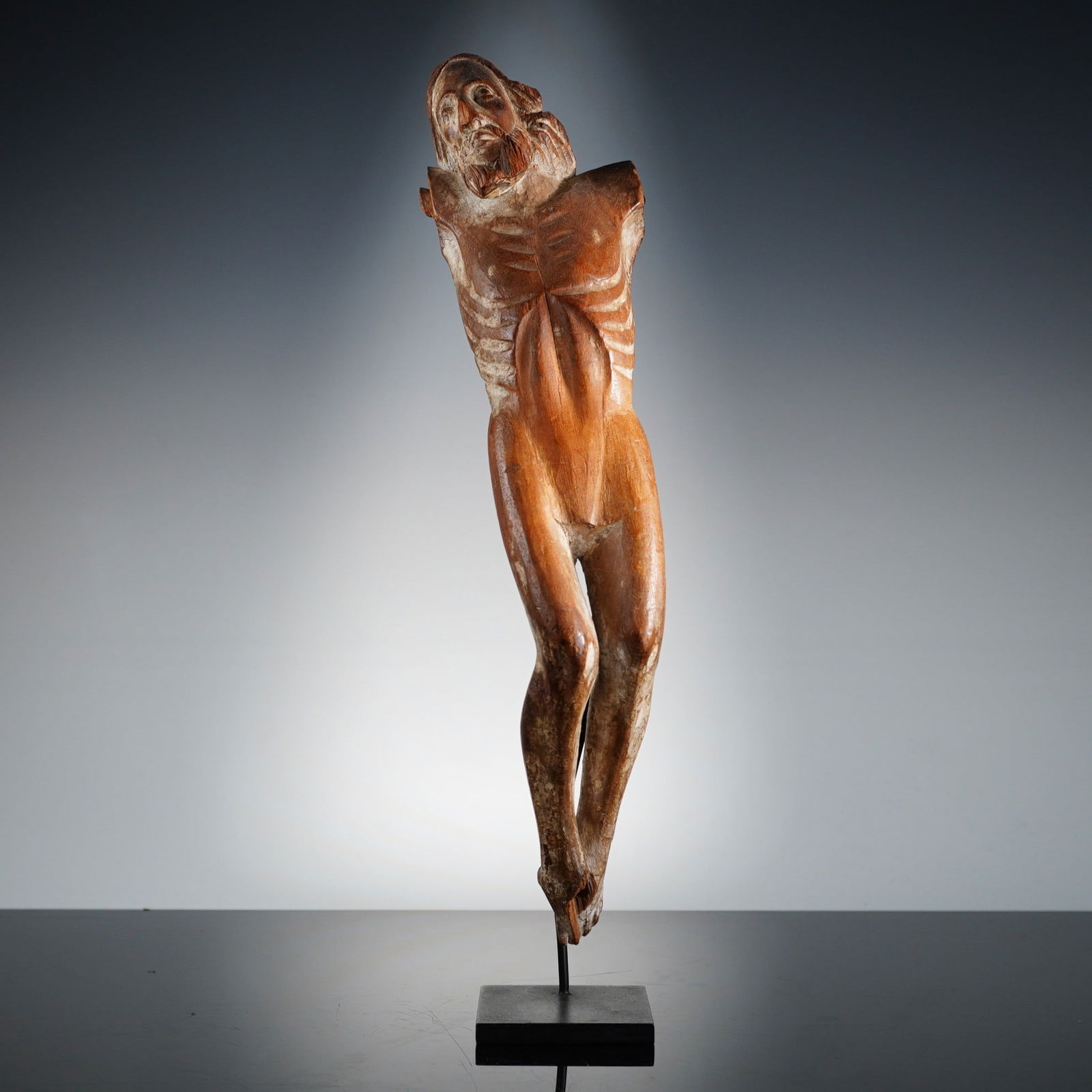 Wooden Carved Crucifixion of Christ: This wooden carved crucifixion of Christ is modeled as a pre-Columbian style anthropomorphic terracotta vessel. The object features a globular body with two small, pierced loop handles at the