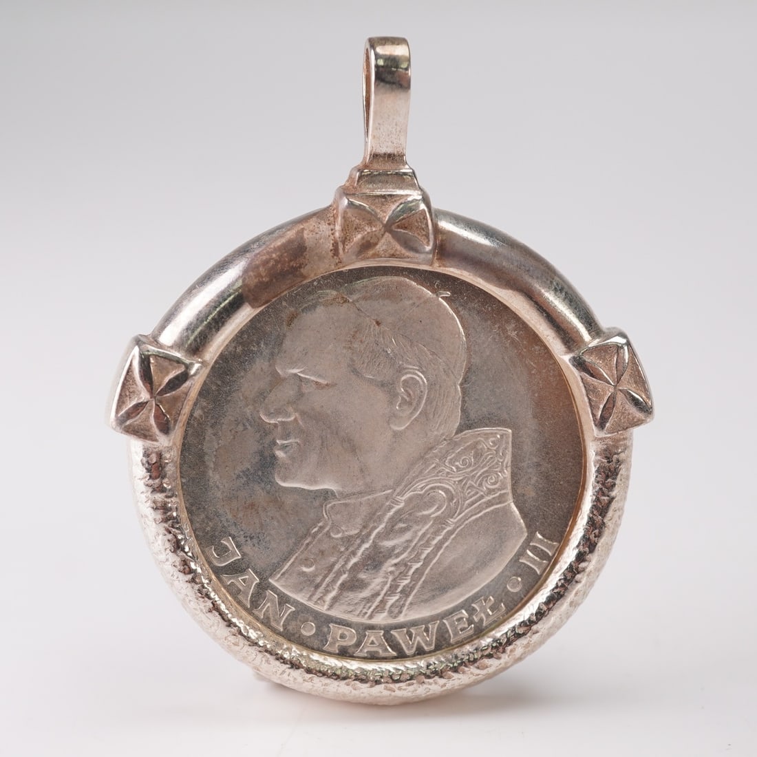 1983 Pope John Paul II Silver 1000 Zlotys in Silver Bezel Pendent: 1983 Poland 1000 Zloty silver commemorative coin featuring Pope John Paul II, securely mounted in a sterling silver bezel designed for wear as a pendant. The obverse of the coin presents the crowned W