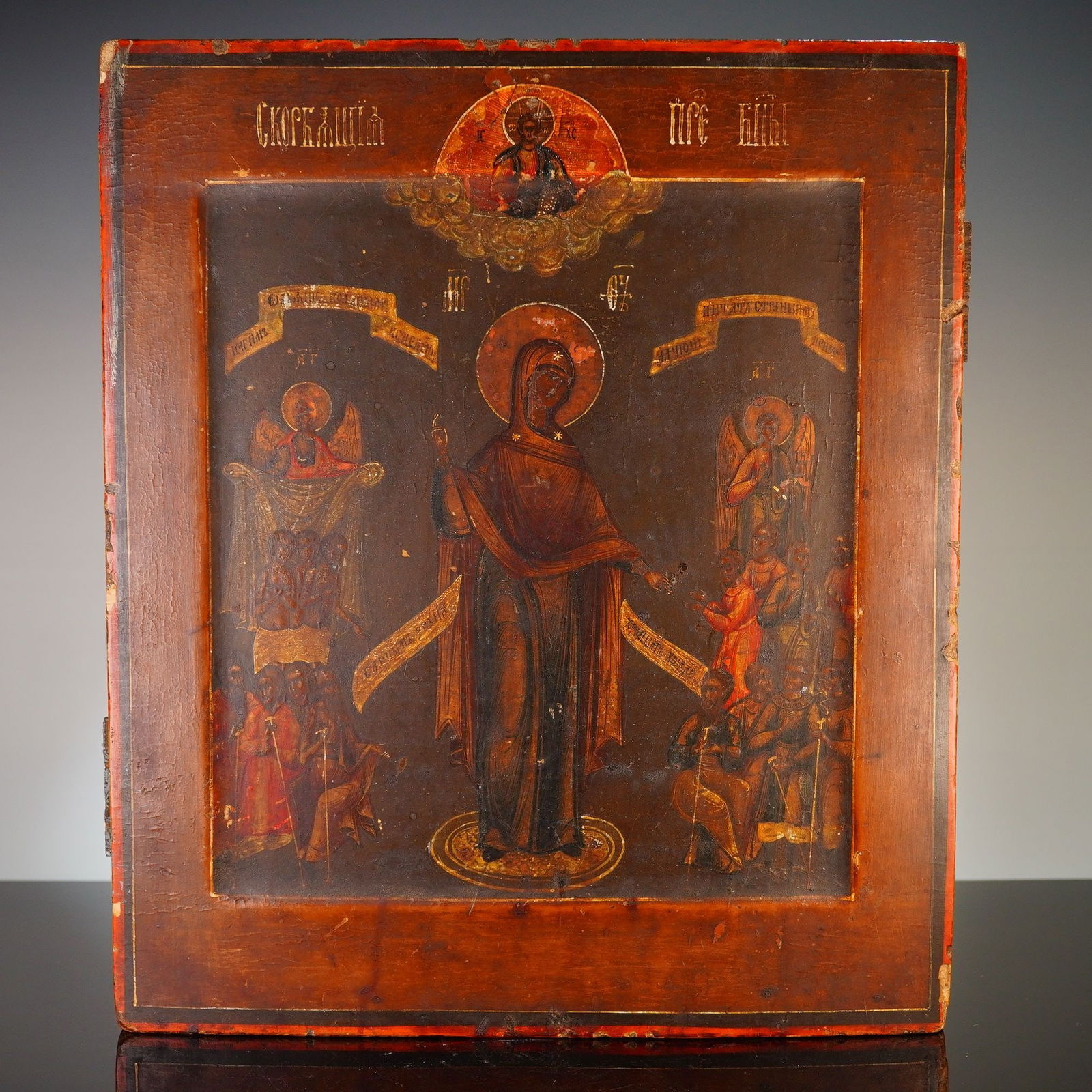 19th Century Russian Orthodox Icon of the Mother of God: This 19th century Russian Orthodox icon of the Mother of God, known as the Joy of All Who Sorrow, is a painting on a wooden panel rendered in tempera and gold leaf. The central composition depicts the