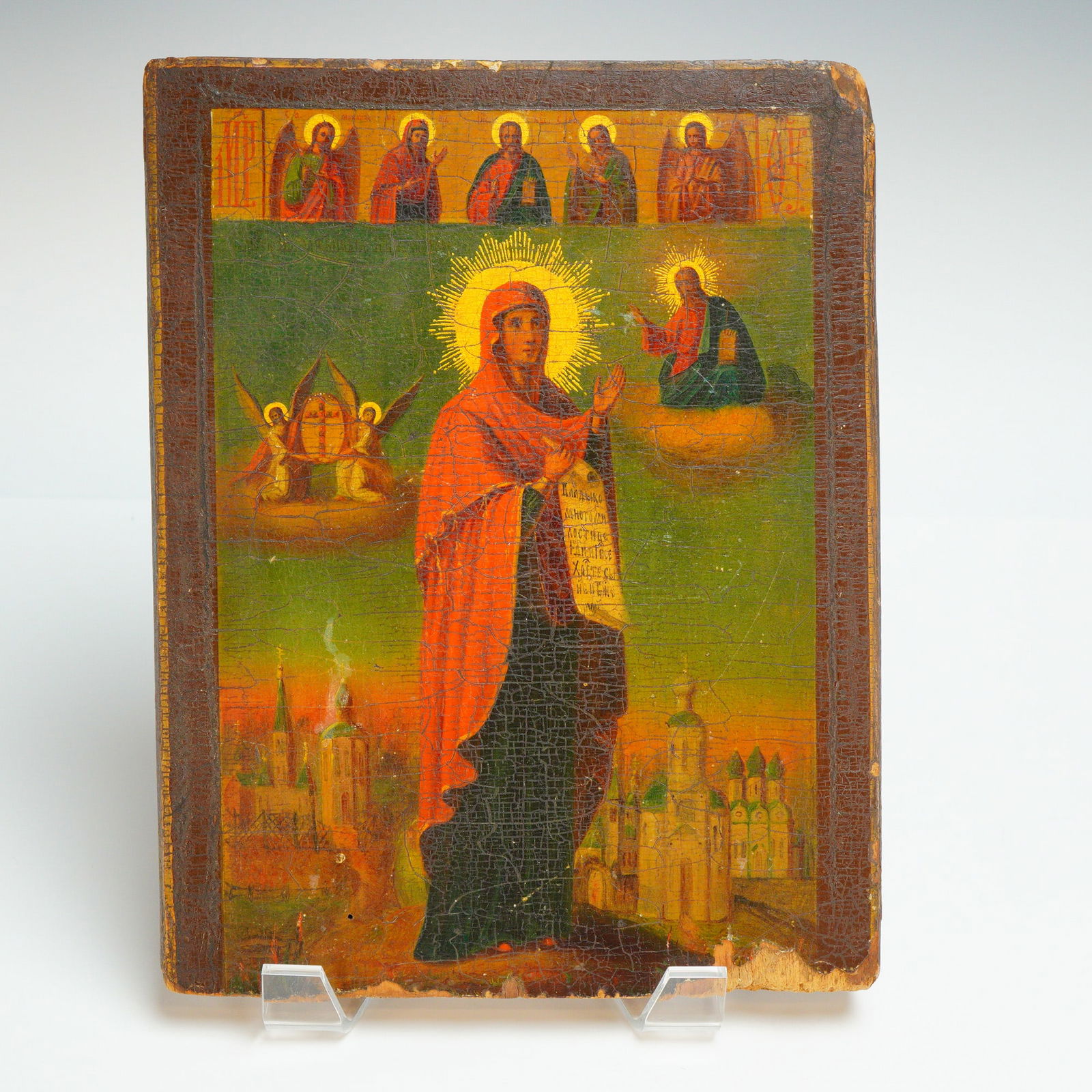 Russian Icon Mother of God, Joy of All Who Sorrow: This wooden Russian Mother of God icon, titled Joy of All Who Sorrow, is a painted wall decoration executed in tempera or oil on a wooden panel. The central composition features a standing Mother of G