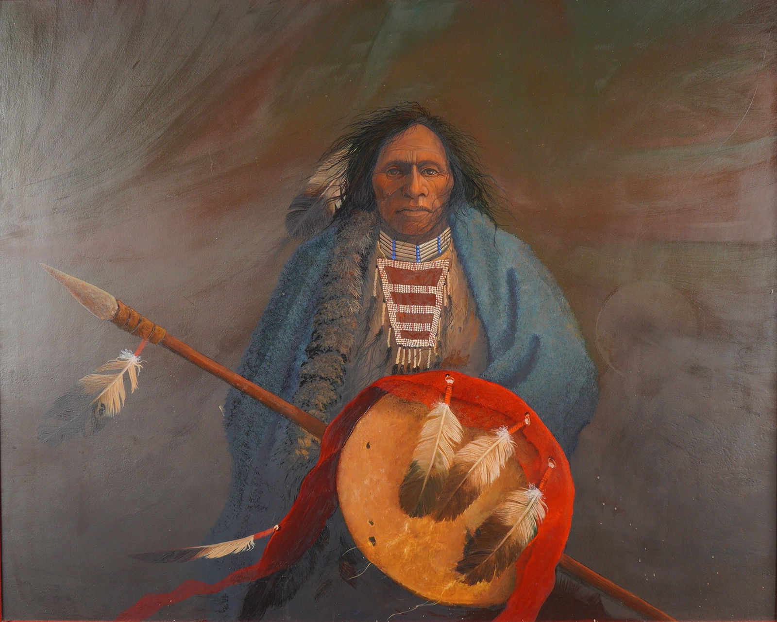 Mark Rohrig (American, b. 1955), 'Native American Warrior with Drum and Spear', (Signed): Mark Rohrig (American, b. 1955), oil and acrylic on board. This Mystic Realist portrait depicts a Native American elder or warrior from the waist up, draped in a textured blue blanket and wearing an i