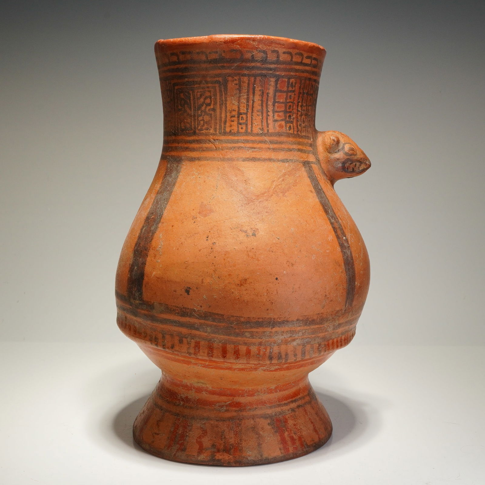 Pre-Columbian Greater Nicoya Pottery Jar with Jaguar Effigy: This polychrome ceramic vessel is attributed to the Greater Nicoya culture of the Nicoya Peninsula, Costa Rica, dating approximately 1000-1350 AD. The earthenware jar features a bulbous body tapering