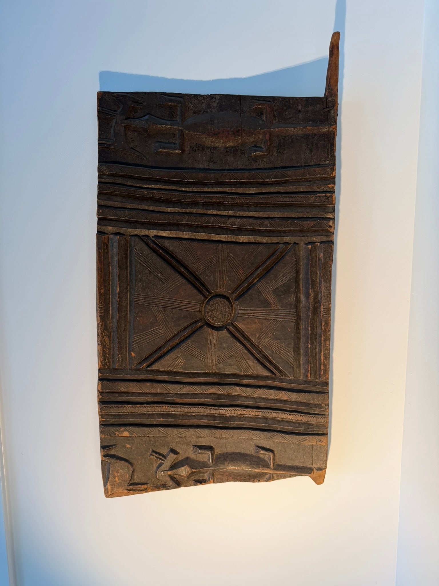 Senufo Carved Granary Door Fragment, Cote d'Ivoire, 19th/20th Century: A Senufo door from Cote d'Ivoire, carved from dense, dark hardwood, identified as a granary door fragment traditionally made by the Senufo people. These doors were historically used to protect stored