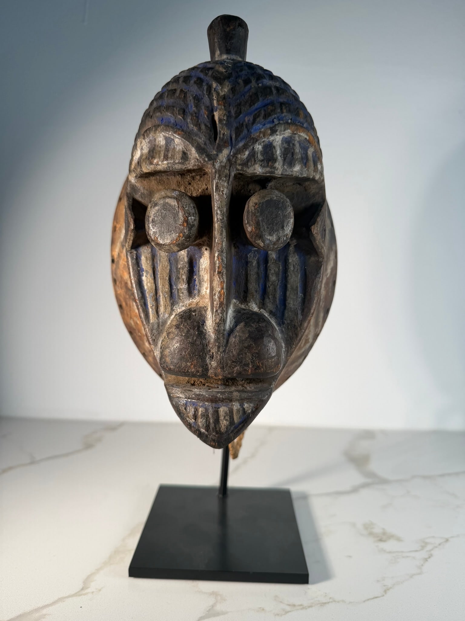 Ijo Water Spirit Headdress Mask, Niger Delta, Nigeria, 19th Century: An Ijo Water Spirit headdress, carved from dark wood, attributed to the late 19th century and originating from the Niger Delta region of Nigeria. This sculptural headpiece features a convex, oval face