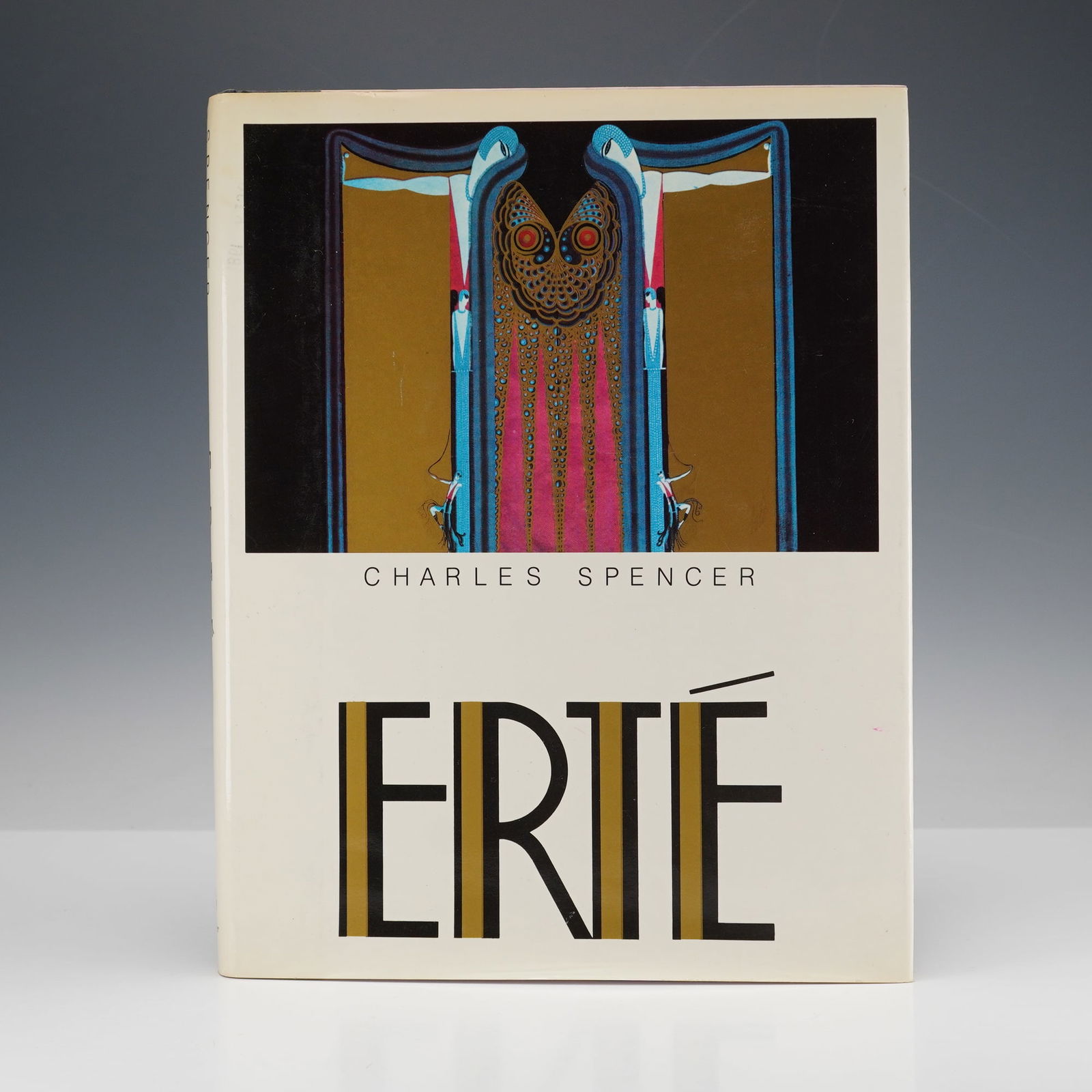 Charles Spencer Hardcover Book, Erte: Erte by Charles Spencer, published by Clarkson Potter in 1981. This hardcover book, written in English, explores the life of the avant-garde artist and dress designer Erte. The book surveys his influe