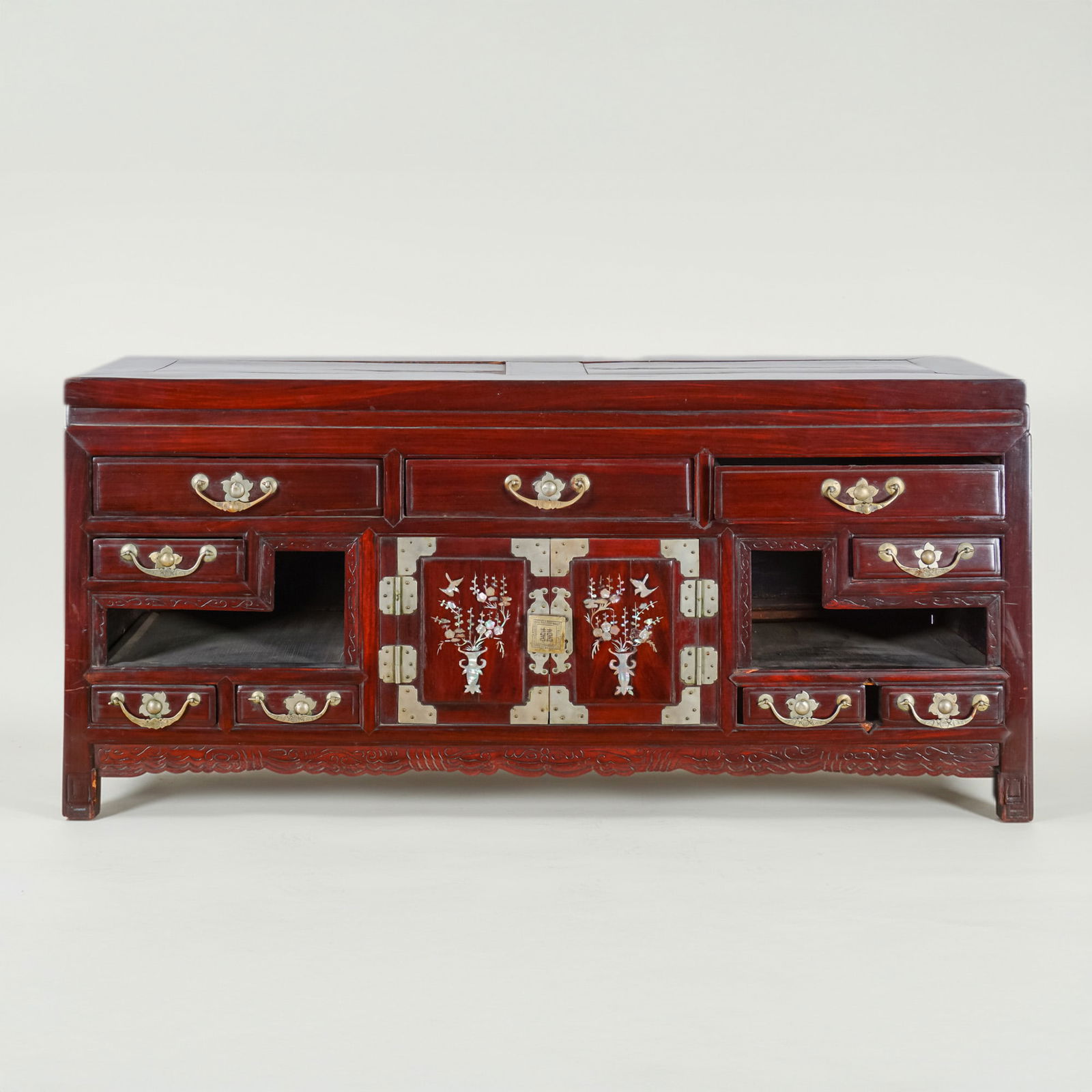 Korean Elm Bandaji Chest with Brass and Mother-of-Pearl Inlay, c.1960: An exquisite mid-20th century Korean elmwood Bandaji chest richly adorned with intricate brass mounts and delicate mother-of-pearl inlays. The central double doors feature inlaid vases overflowing wit