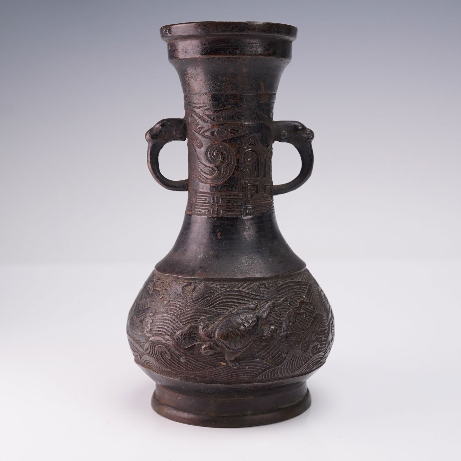 Chinese Ming Dynasty Small Bronze Sea Turtle Relief Vase: Chinese Ming Dynasty small bronze vase featuring two handles in the form of possible lion heads or dragon heads. The body of the vase is decorated with an engraved ocean motif and relief