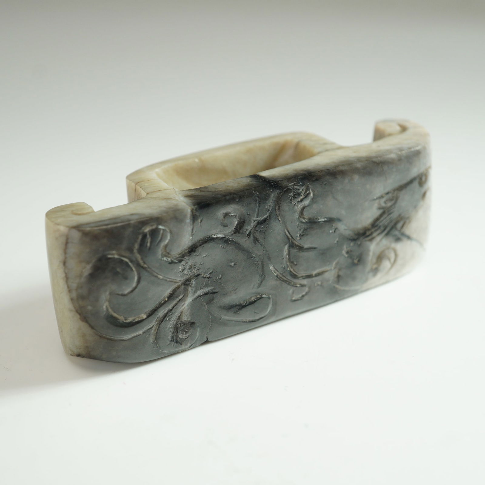 Chinse Ming Dynasty Chilong Jade Sword Slide: Chinese black and white jade sword slide carved in low relief with a depiction of a Chilong, a traditional mythical creature symbolizing goodness, justice, and prosperity in Chinese Taoist culture.