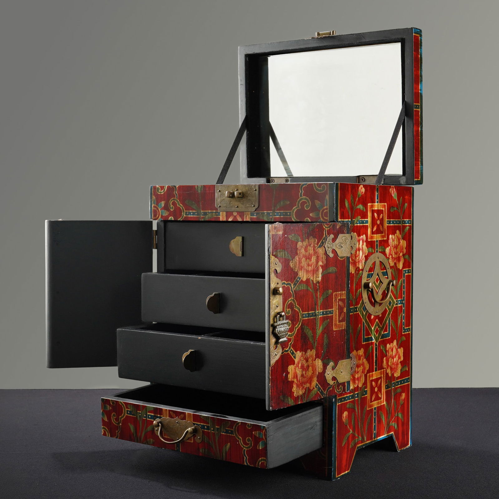 Chinese Red Lacquered Floral Jewelry Box: This Chinese wooden jewelry chest features a red lacquered ground decorated with hand-painted floral peonies, scrolling vines, and geometric motifs. The exterior is fitted with brass-toned hardware, d