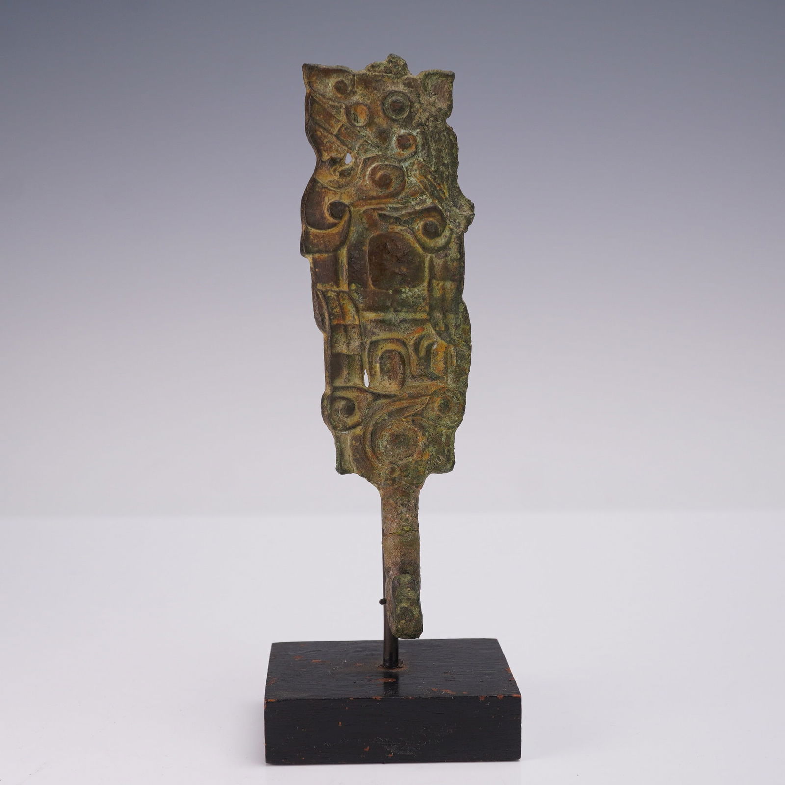 2pc Chinese Bronze Belt Hook with Stand: The belt hook is cast in bronze and decorated with an archaic design consisting of raised scrollwork, circular patterns, and linear motifs. The front surface shows distinct relief decoration, while th