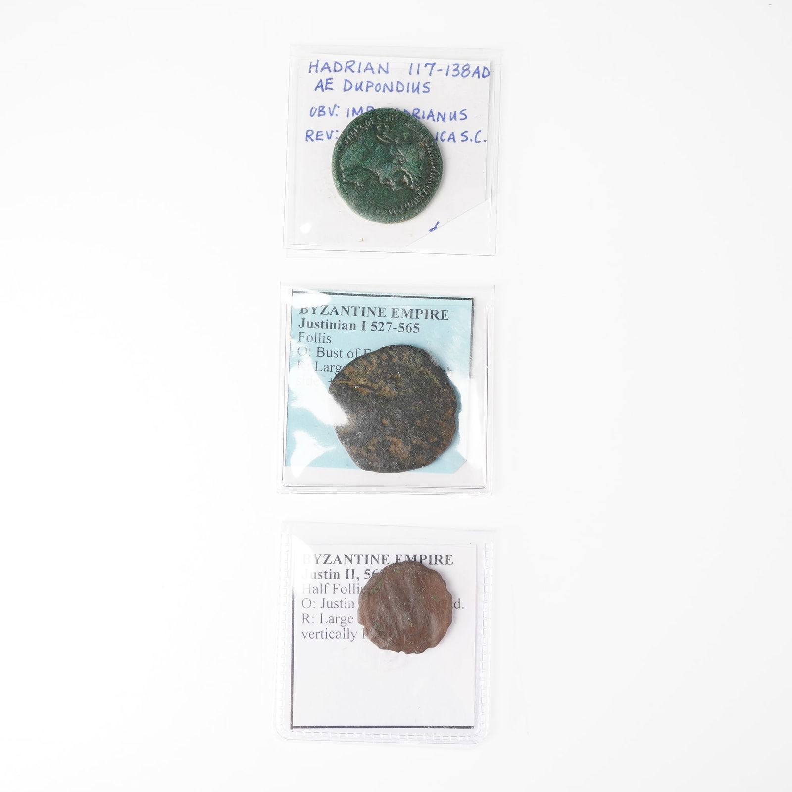 3pc Ancient Roman & Byzantine Coins: A AE dupondius of Hadrian (117-138 AD) showing a laureate bust right on the obverse with the inscription IMP CAESAR TRAIAN HADRIANVS AVG and a standing figure on the reverse with S C, struck in