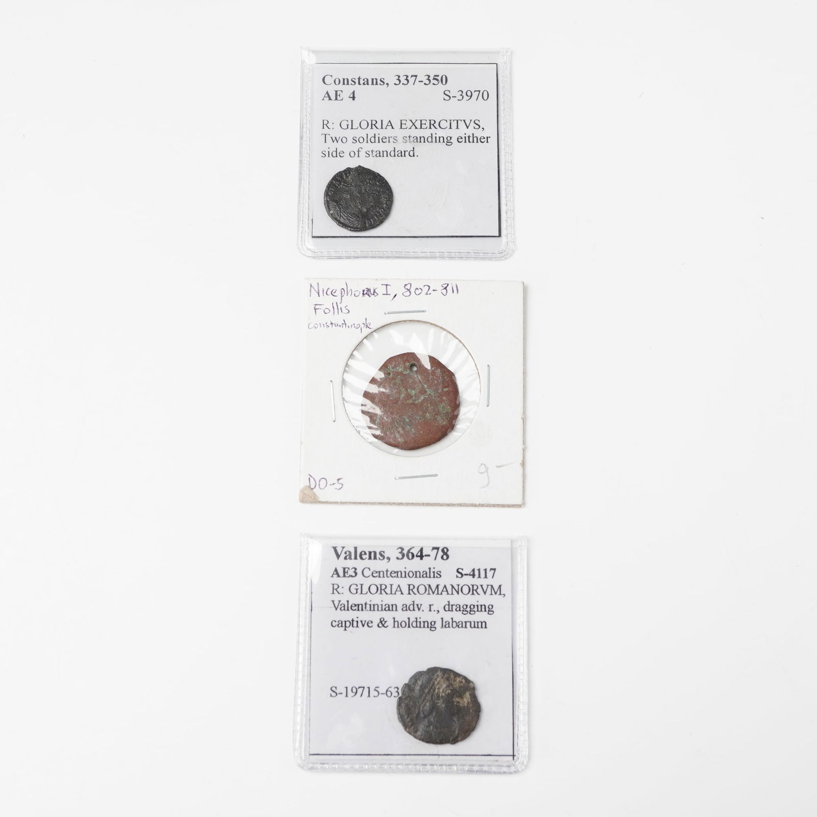 3pc Ancient Roman Coins: Includes one AE3 centenionalis of Emperor Valens (AD 364-378) with an obverse portrait bust and reverse showing VALENTINIAN ADVANCING RIGHT, DRAGGING CAPTIVE AND HOLDING LABARUM, inscribed GLORIA
