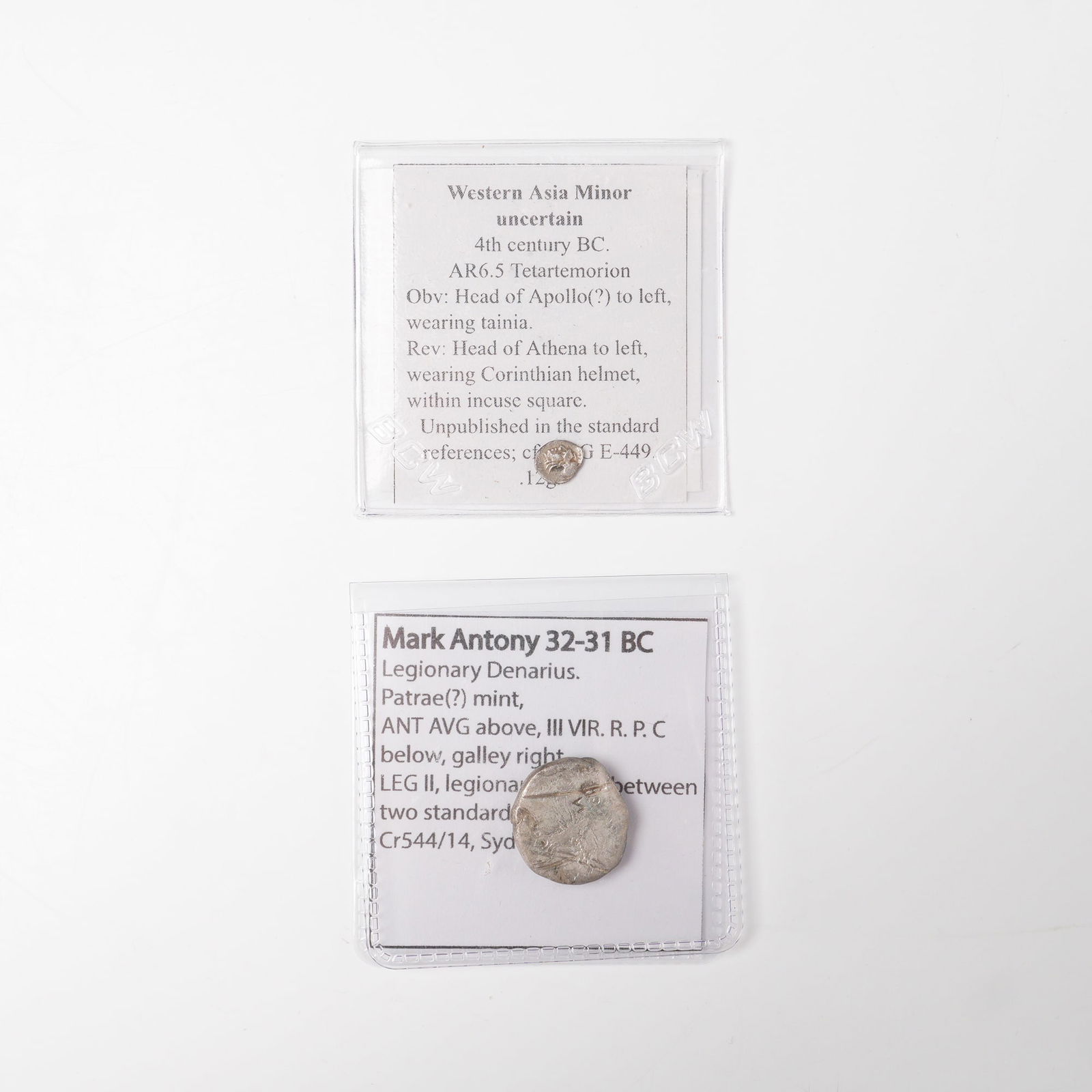 2pc 32 - 31 B.C Mark Antony Legionary Denarius and Western Asia Minor Coins: This lot includes a confirmed Roman silver legionary denarius of Mark Antony from 32 to 31 BC, showing a galley on one side and legionary standards marked LEG II on the other. It is accompanied by a