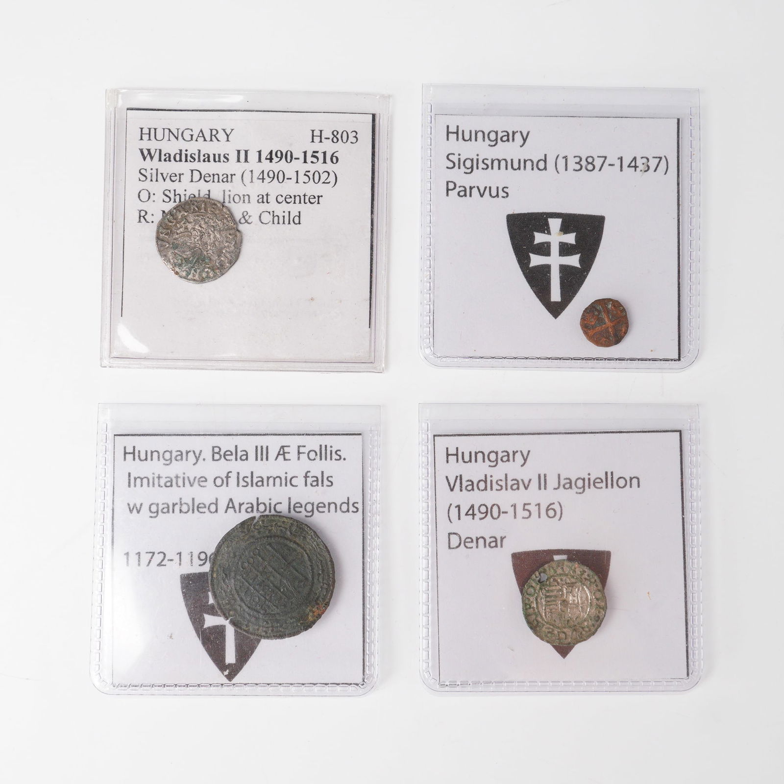 4pc Medieval Hungarian Coins: This collection includes four Hungarian coins spanning from the twelfth to sixteenth centuries. The earliest is a bronze follis of Bela III (1172 - 1196), imitative of Islamic fals with garbled