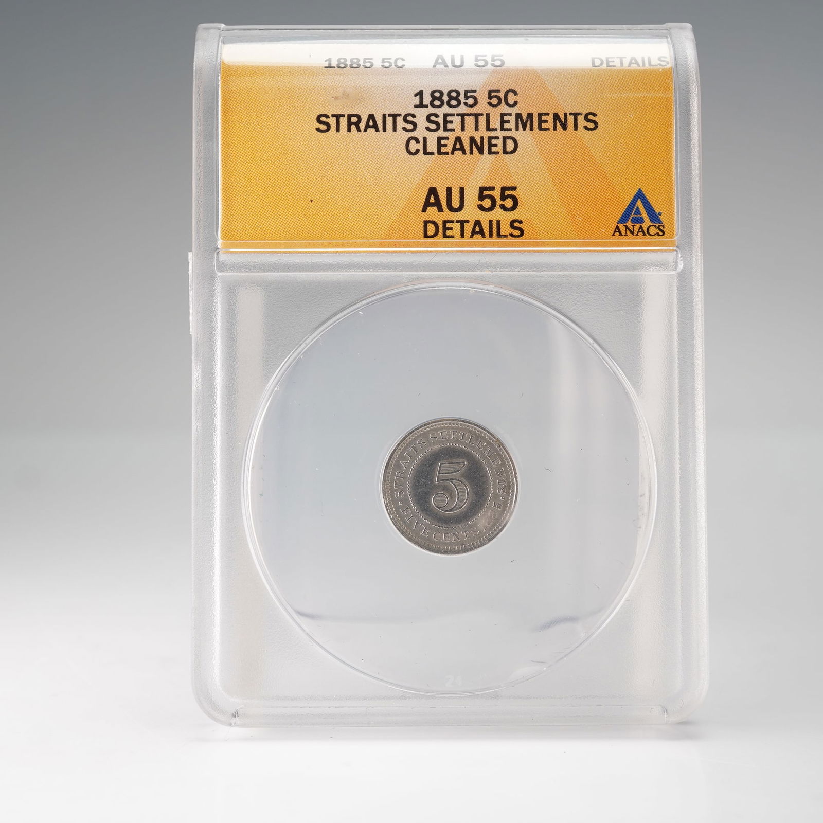 1885 Straits Settlements 5 Cents ANACS Graded AU 55: A silver 5 Cents coin from the Straits Settlements, dated 1885 and graded AU55 Details (Cleaned) by ANACS. The obverse features the crowned portrait of Queen Victoria facing left, designed by William