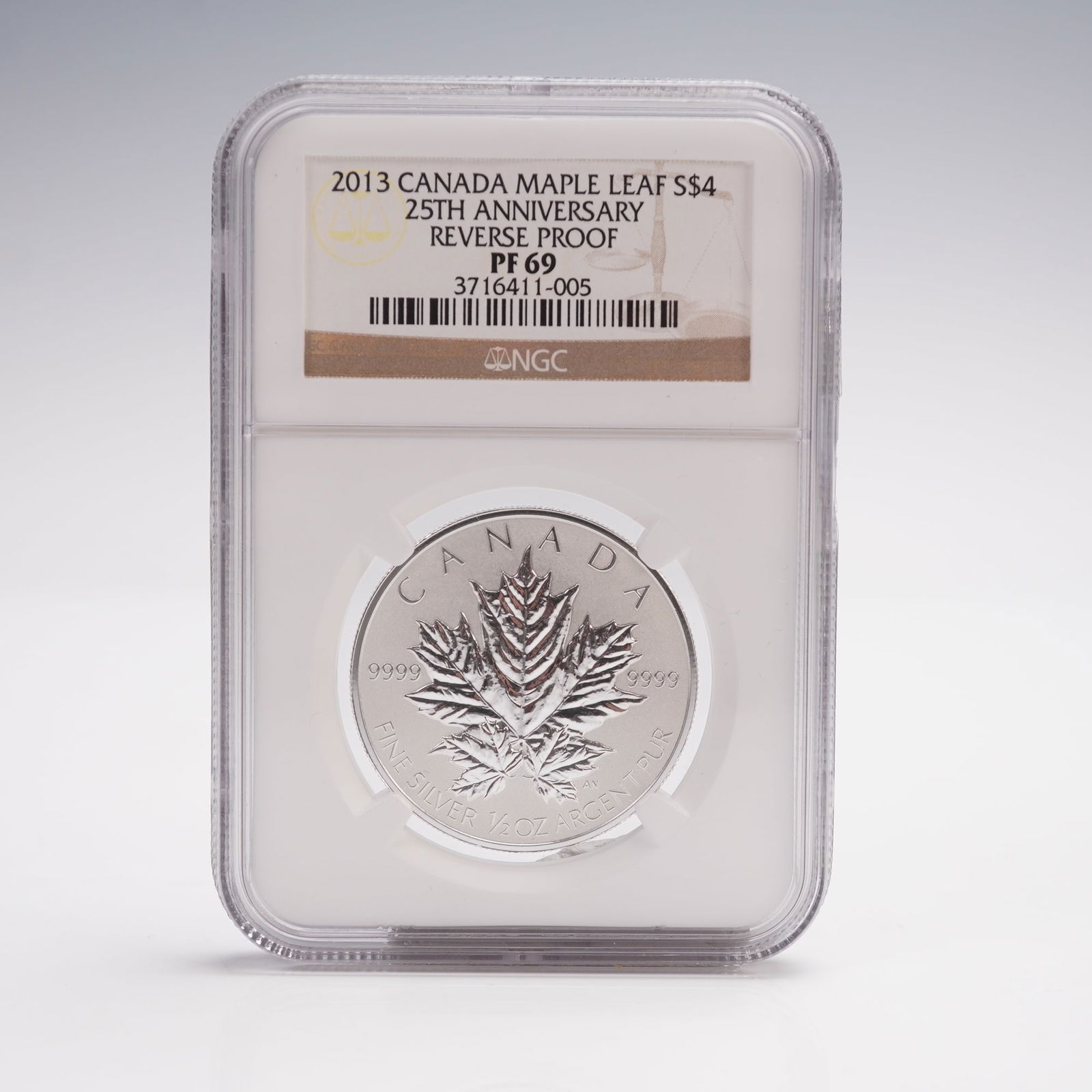 2013 Canada Maple Leaf 5 Dollar 25th Anniversary Coin NGC Graded PF-69: Issued to commemorate the 25th anniversary of the series. Struck in one troy ounce of .9999 fine silver, this reverse proof features a central design of three overlapping maple leaves on the reverse,
