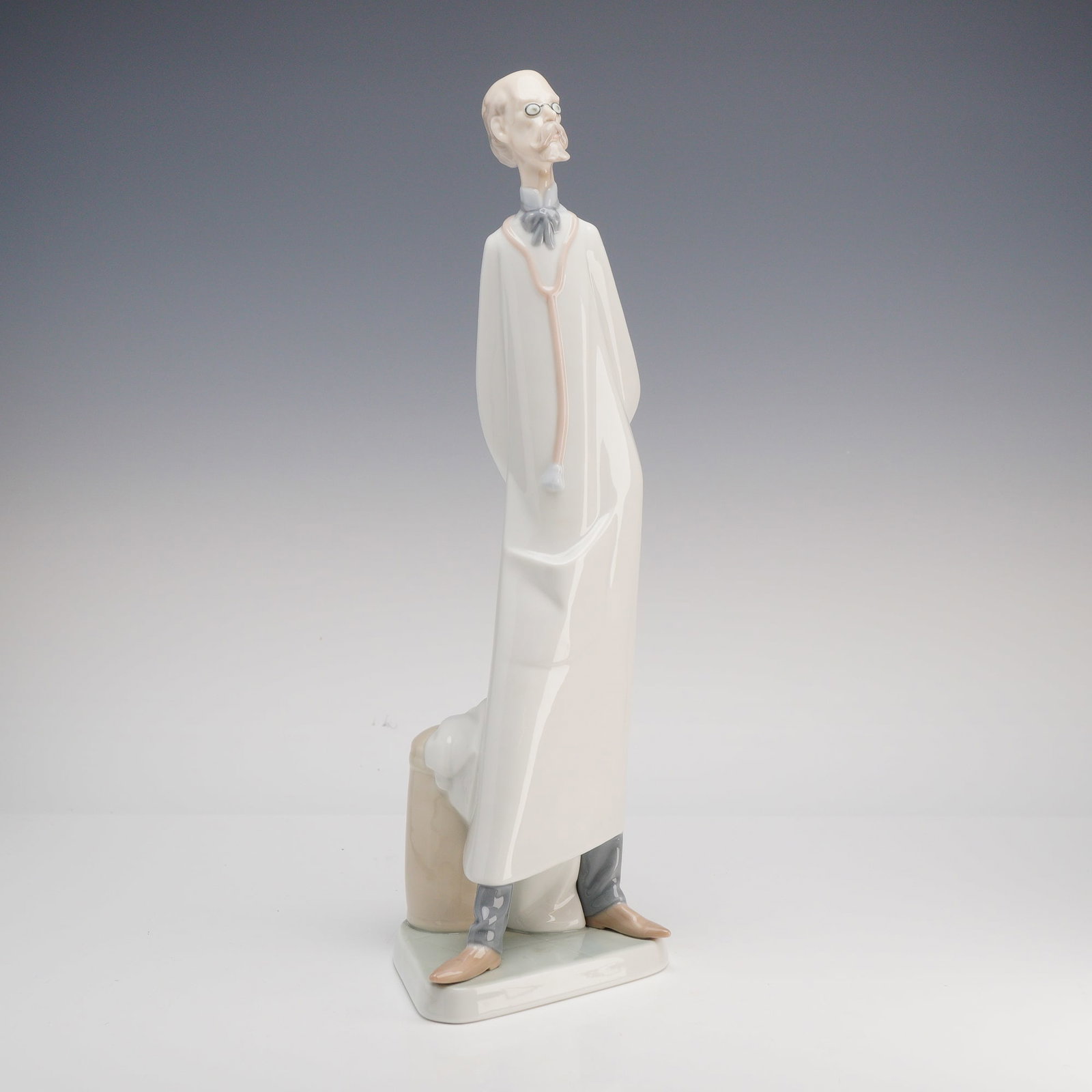 Lladro, The Doctor Figurine: This is a Lladro glazed porcelain figurine titled The Doctor, also known by the Spanish title Medico, model number 4602. Sculpted by Salvador Furio, the piece depicts an elderly physician in a