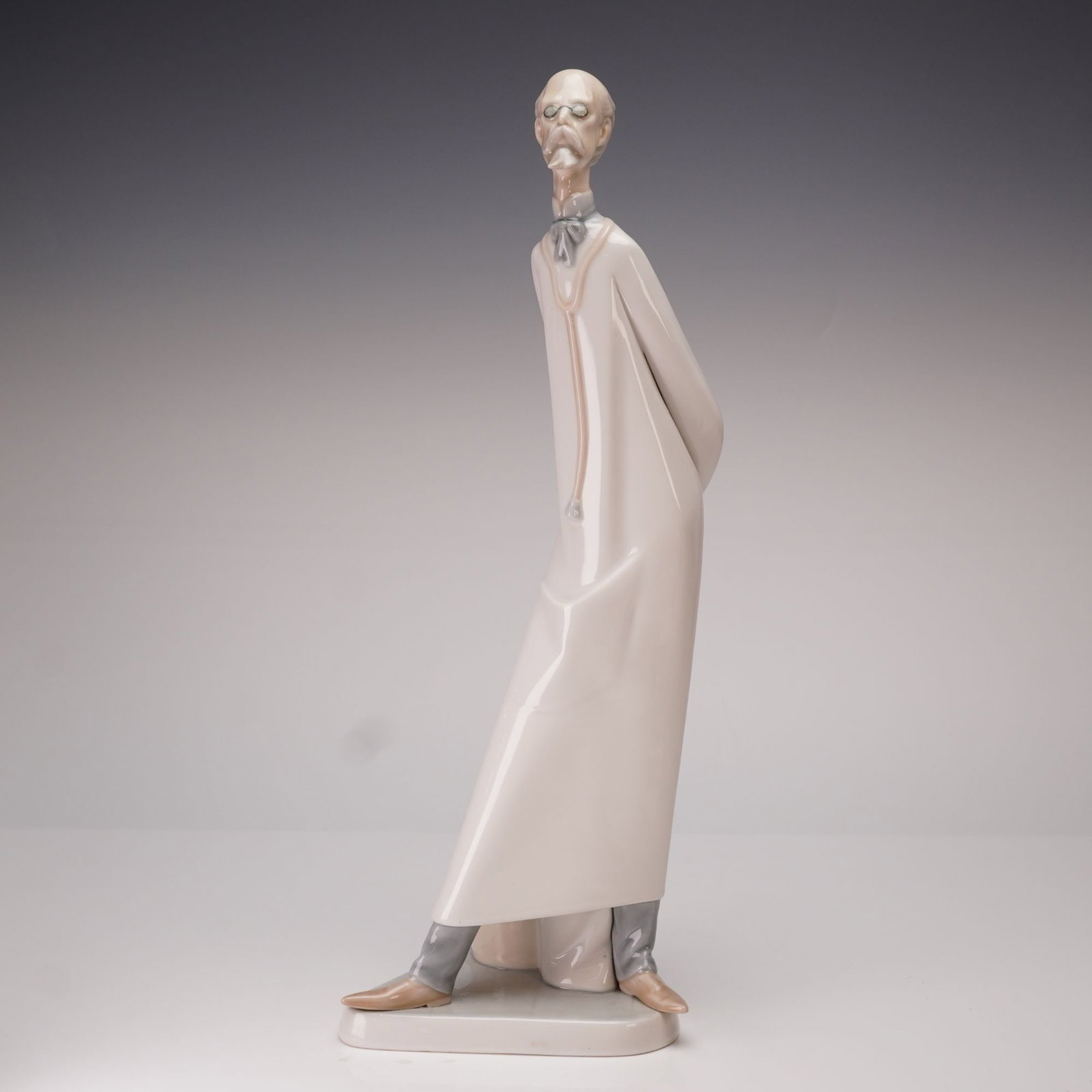 Lladro, Doctor Porcelain Figurine 1004602: This vintage Lladro glazed porcelain figurine, titled Doctor is model number 4602. Sculpted by Salvador Furio and originally issued in 1970, the piece depicts a tall, slender medical professional
