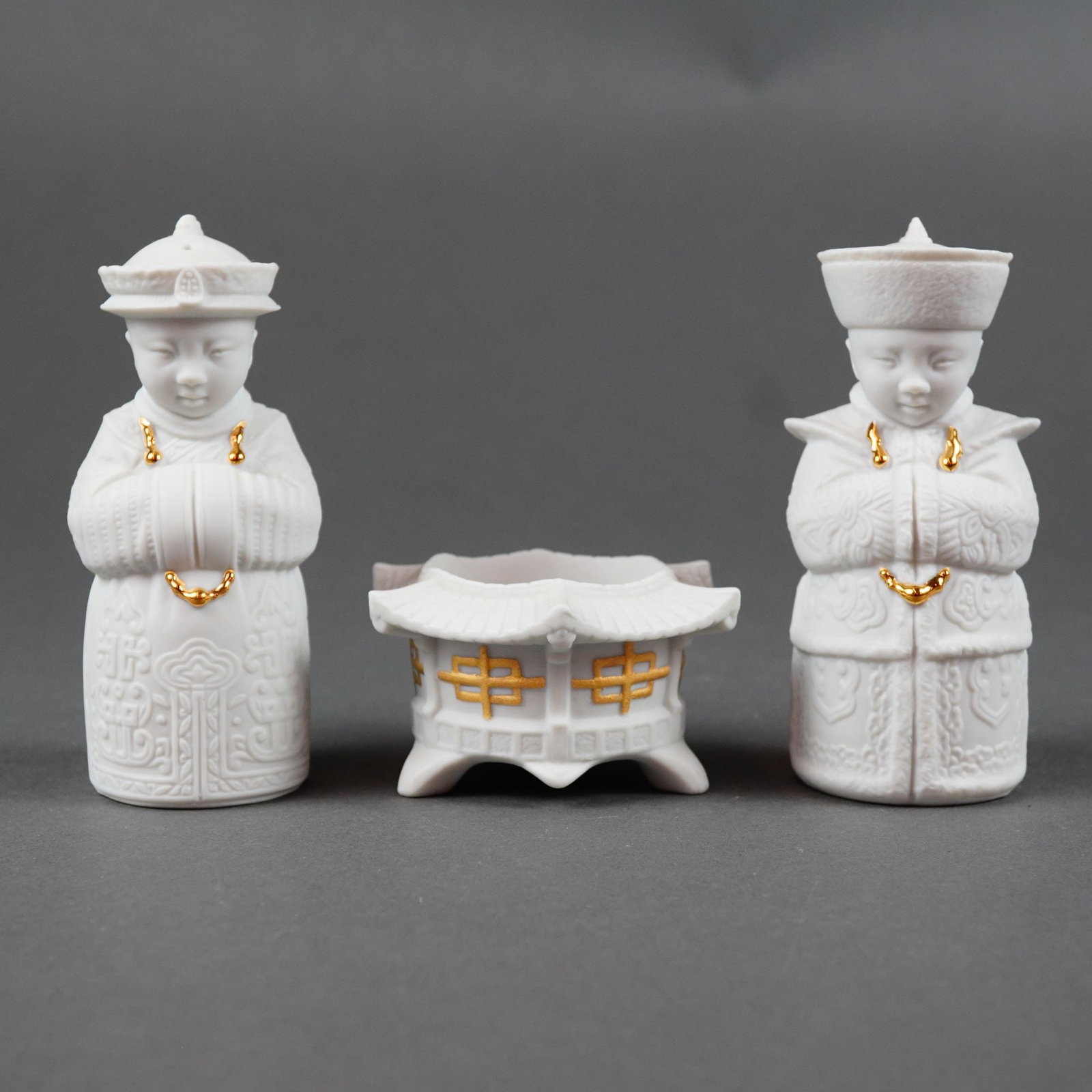 21st Century, Lladro Porcelain, Three-Piece Chinoiserie Table Set: This 3pc Lladro grouping including a pagoda-shaped bowl and salt and pepper shaker pair is dated 2008. The set is finely crafted from matte white biscuit porcelain in the Chinoiserie style,