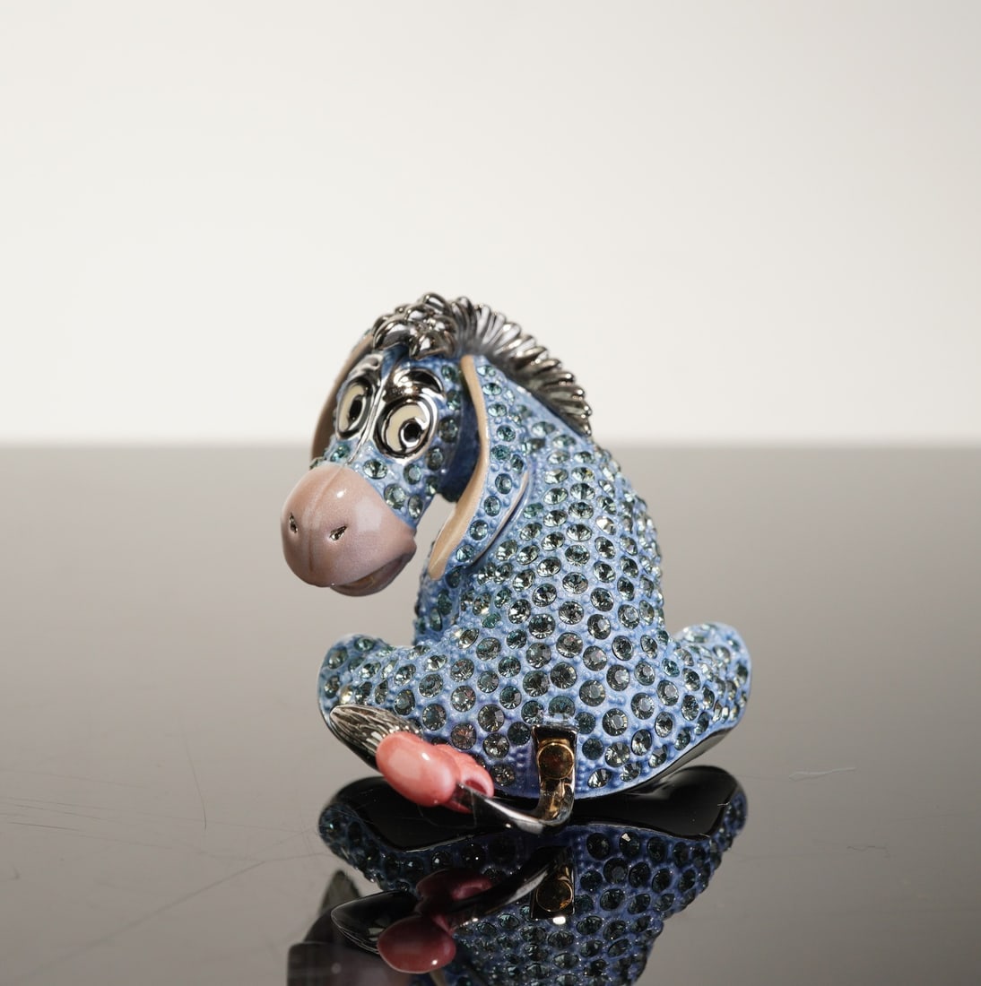 Arribas Brothers Disney Eeyore Swarovski Jeweled Crystal Figurine Trinket Box: Produced by Arribas Brothers for the Arribas Collection, this Disney collectible figurine depicts the character Eeyore from Winnie the Pooh in a sitting pose. The piece is crafted from enameled metal