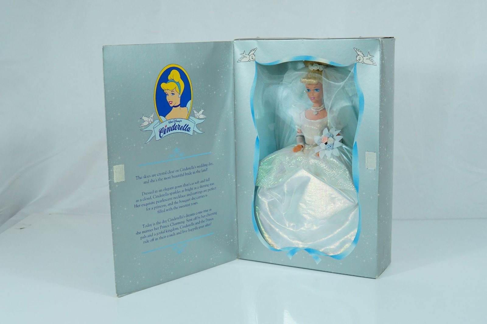 Mattel Walt Disney's Wedding Cinderella 45th Anniversary Doll, 12 inches: Mattel vinyl fashion doll commemorating the 45th anniversary of Walt Disney's 1950 animated film Cinderella. The doll features rooted blonde synthetic hair styled in a formal updo with a pearl-accente