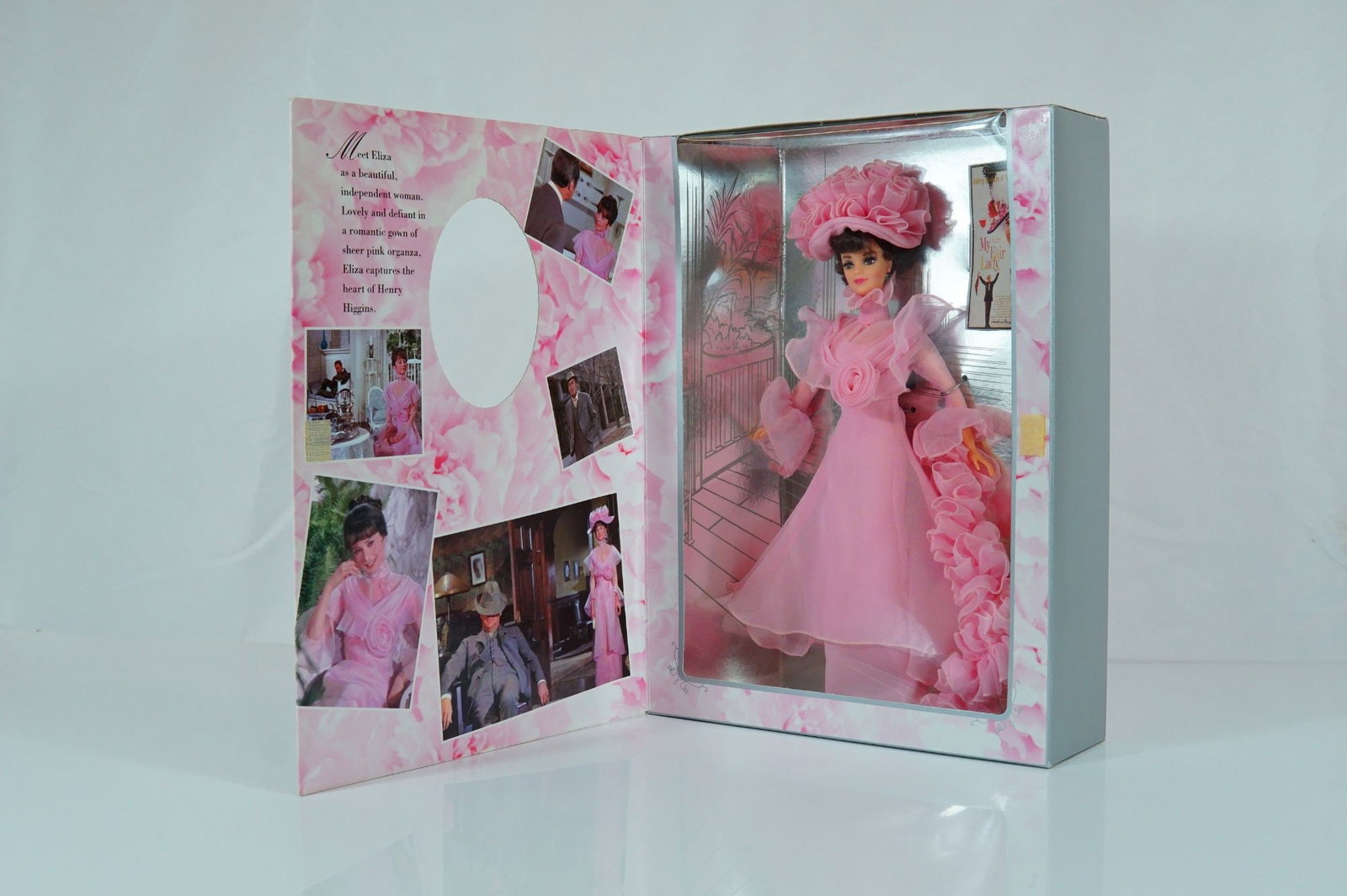 Mattel Barbie as Eliza Doolittle in My Fair Lady Closing Scene, 11.5 Inches: Manufactured by Mattel, this vinyl collector doll is part of the Hollywood Legends Collection, Collector Edition. The doll features rooted dark brown hair styled in an elegant updo and painted brown e