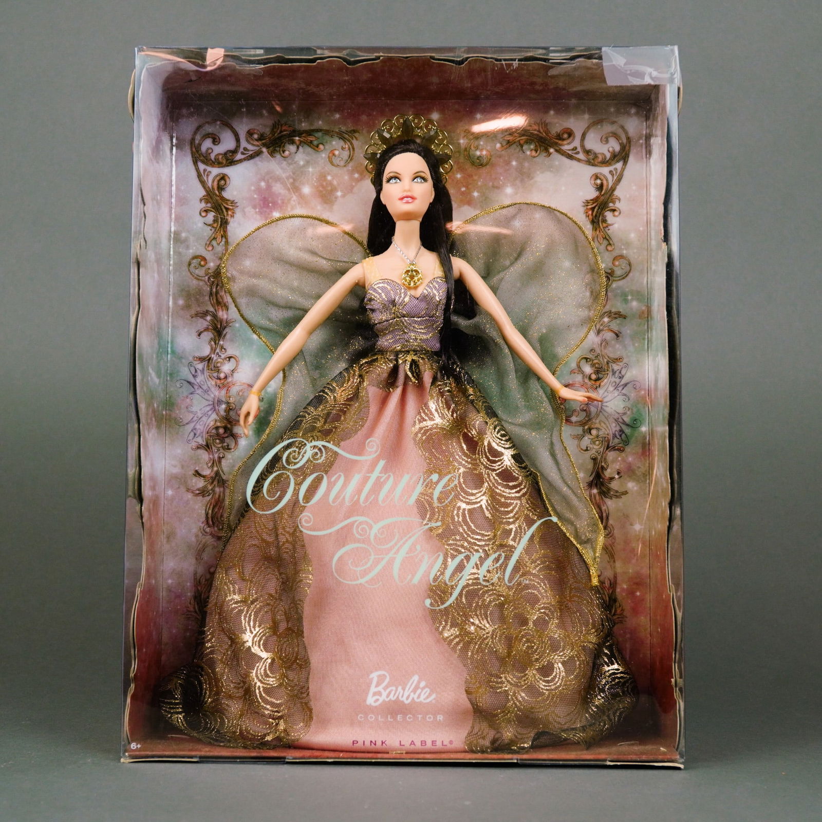 Mattel Barbie Collector Couture Angel Doll, Pink Label, 11.5 Inches: Manufactured by Mattel, Inc., this vinyl fashion doll is the 2011 Couture Angel from the Pink Label Collection (Product Code T7898). The doll features rooted long dark brunette hair and fixed painted