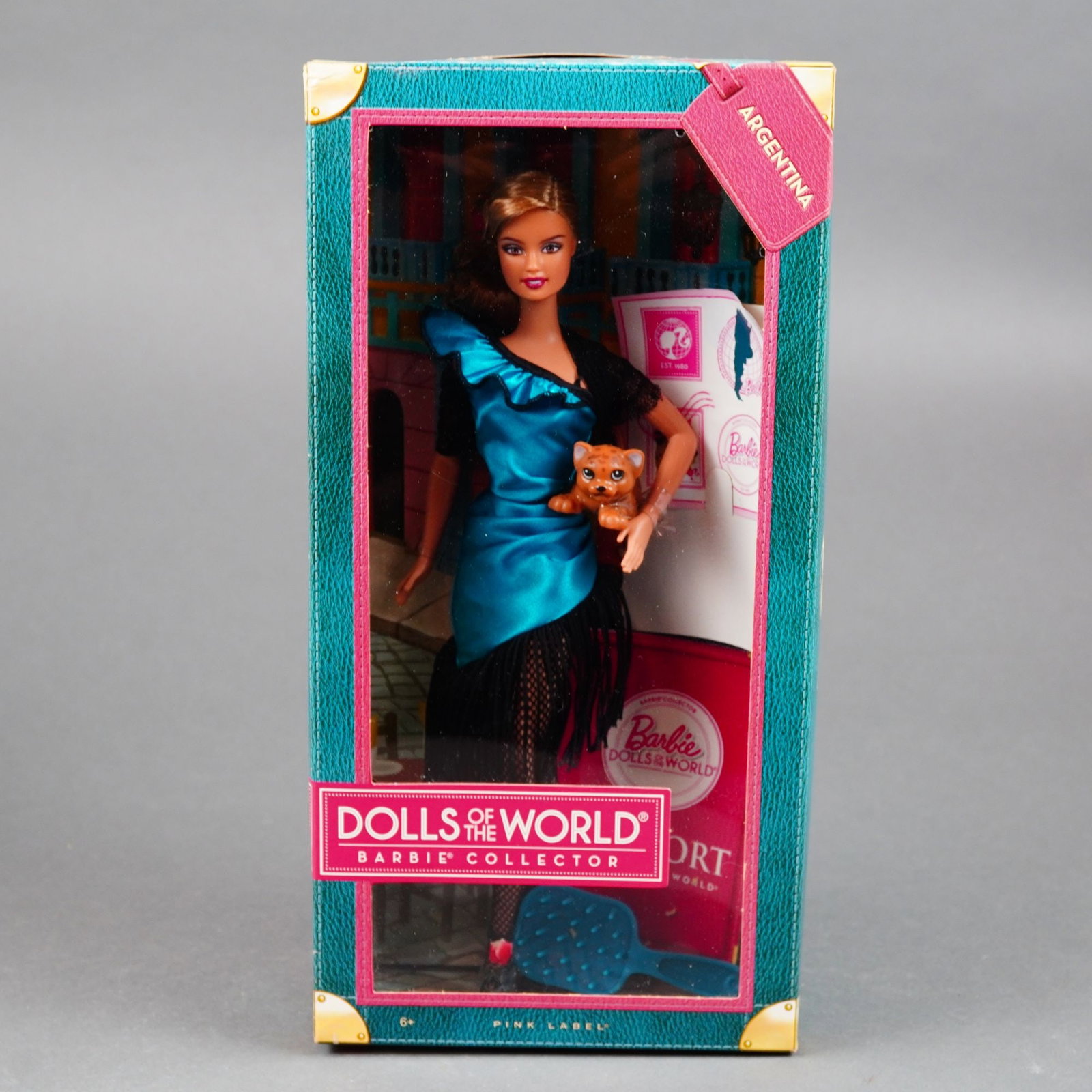 Mattel Barbie Dolls of the World Argentina Collector Doll, 11.5-inch: Manufactured by Mattel, Inc. as part of the Pink Label collection, this vinyl collector doll represents Argentina. The doll features rooted dark brown synthetic hair styled in a sleek low-side bun and