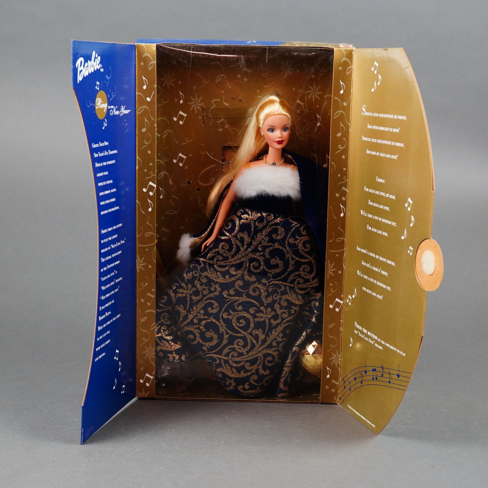Mattel, Ring in the New Year Barbie Doll, 11.5 Inches: Manufactured by Mattel, this 2001 "Ring in the New Year" Barbie doll (model 52742) features a vinyl articulated body with stationary painted blue eyes and rooted blonde hair styled straight. The doll