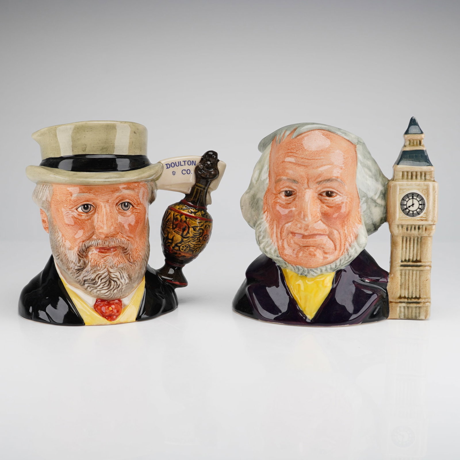 2pc Royal Doulton Character Jugs, John Doulton and Sir Henry Doulton: A pair of small Royal Doulton glazed ceramic character jugs produced exclusively for the Royal Doulton International Collectors Club. The lot includes the John Doulton 8 O'Clock jug (D 6656), issued i