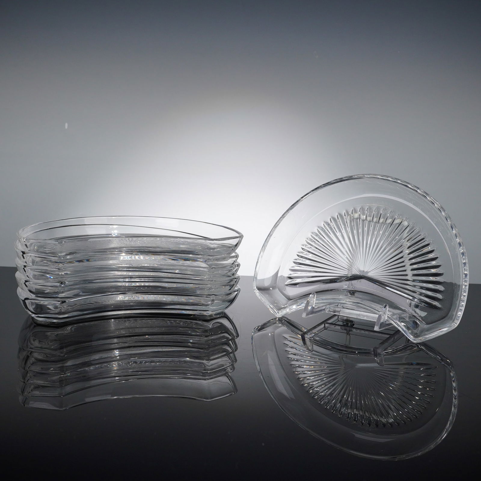 Val Saint Lambert Radial Cut Crystal Crescent Salad Plates: This set of six Val Saint Lambert crystal crescent salad plates, also known as bone plates, is a fine example of Belgian lead crystal craftsmanship. Each plate features a sophisticated deep-cut