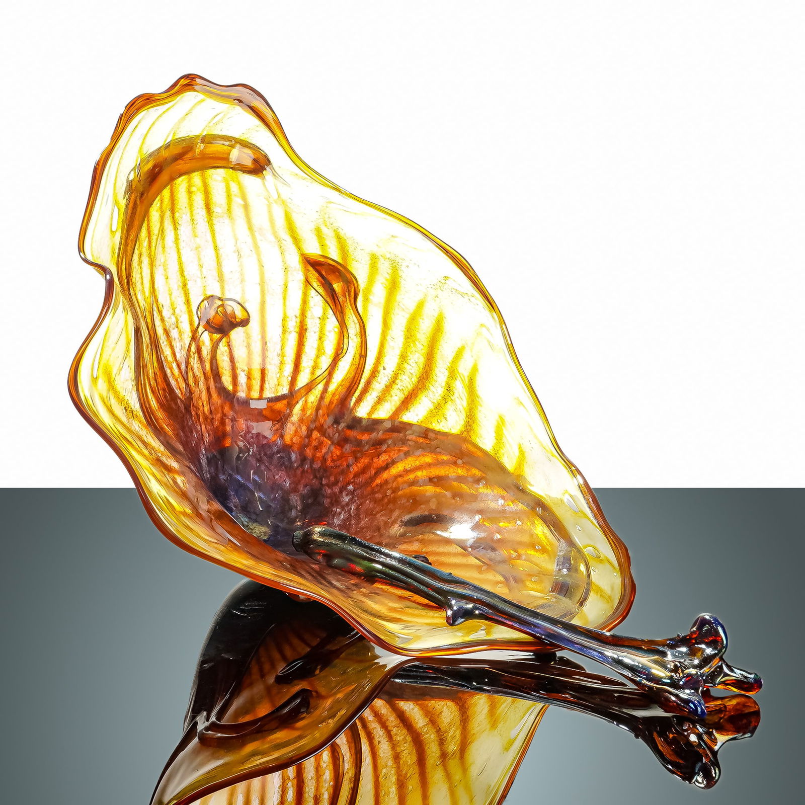 Attributed to Dale Chihuly 2pc Hand-Blown Glass Sculptures Signed: Two-piece hand-blown glass sculptures attributed to American artist Dale Chihuly, created in 2006. The vessel and its accompanying iridescent, gnarled piece feature a fluid organic form. The transluce