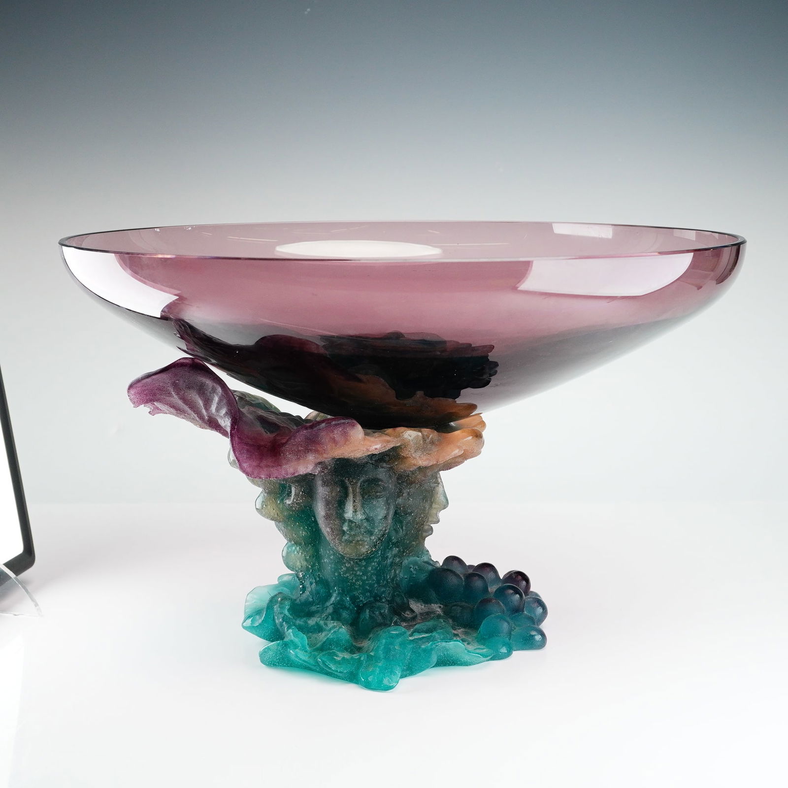 Daum France Signed Pate de Verre Bacchus Centerpiece Bowl: This exceptional Daum France Bacchus centerpiece bowl showcases the technical mastery of French glassmaking. The piece features a pedestal base produced using the complex pate de verre technique,