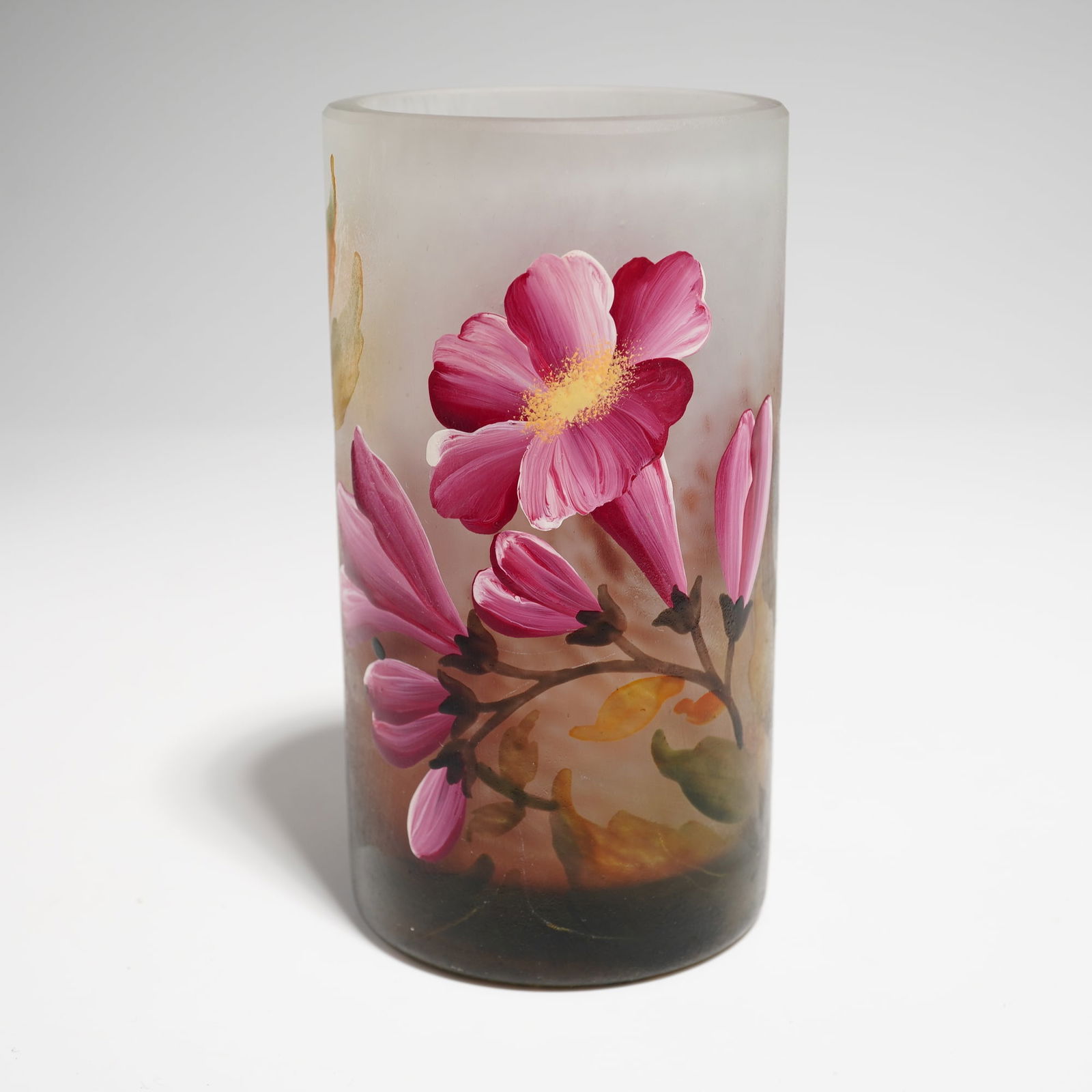 Daum France Art Nouveau Cameo Enameled Glass Vase: This Daum France Art Nouveau cameo enameled glass vase is designed in a cylindrical form with a frosted ground. The color palette transitions from a dark chocolate brown at the base to a translucent w