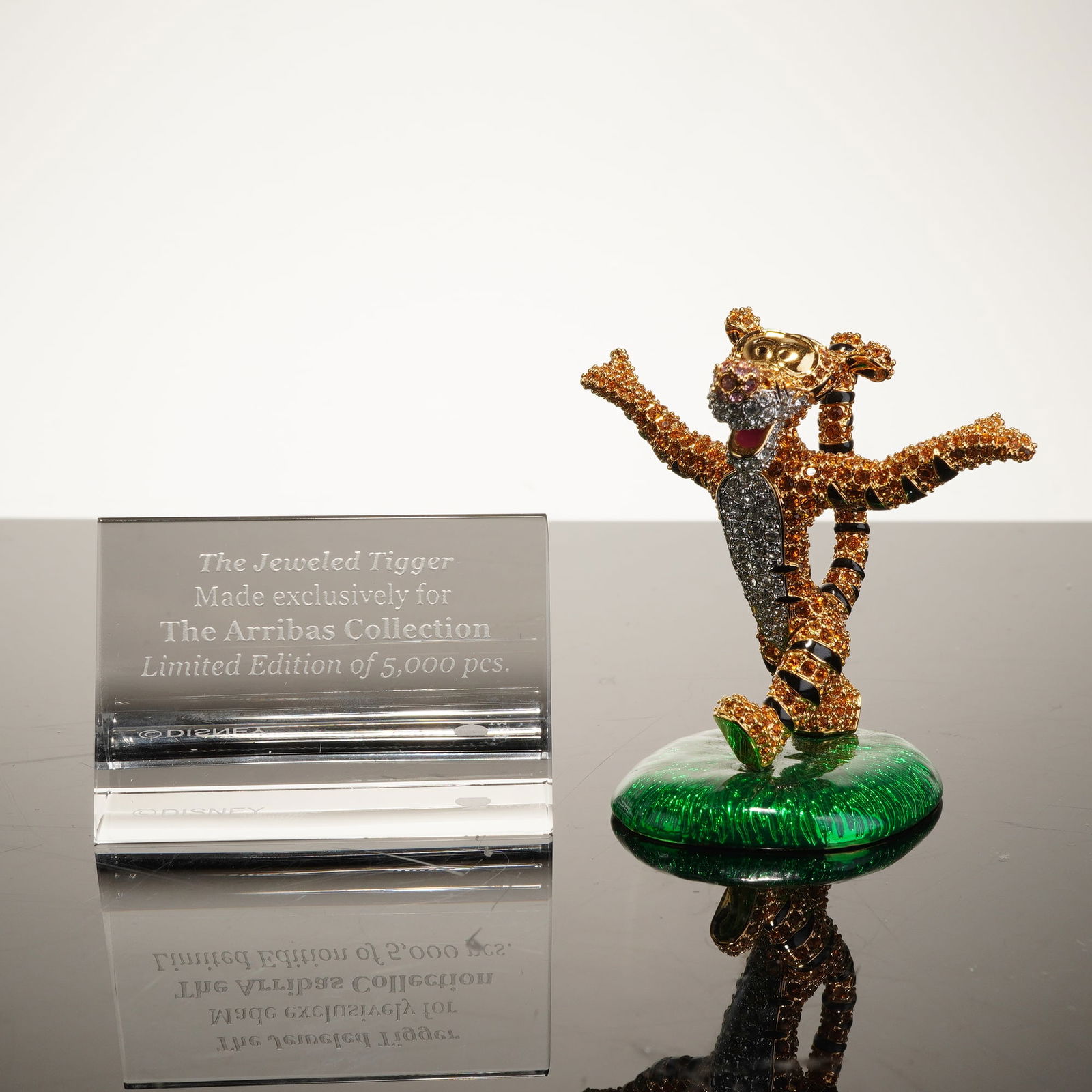 Arribas Brothers The Jeweled Tigger Swarovski Crystal Figurine: This 2pc Arribas collection Swarovski crystal figurine set features "The Jeweled Tigger," produced by Arribas Brothers under license from Disney. The piece is meticulously crafted from gold-toned meta