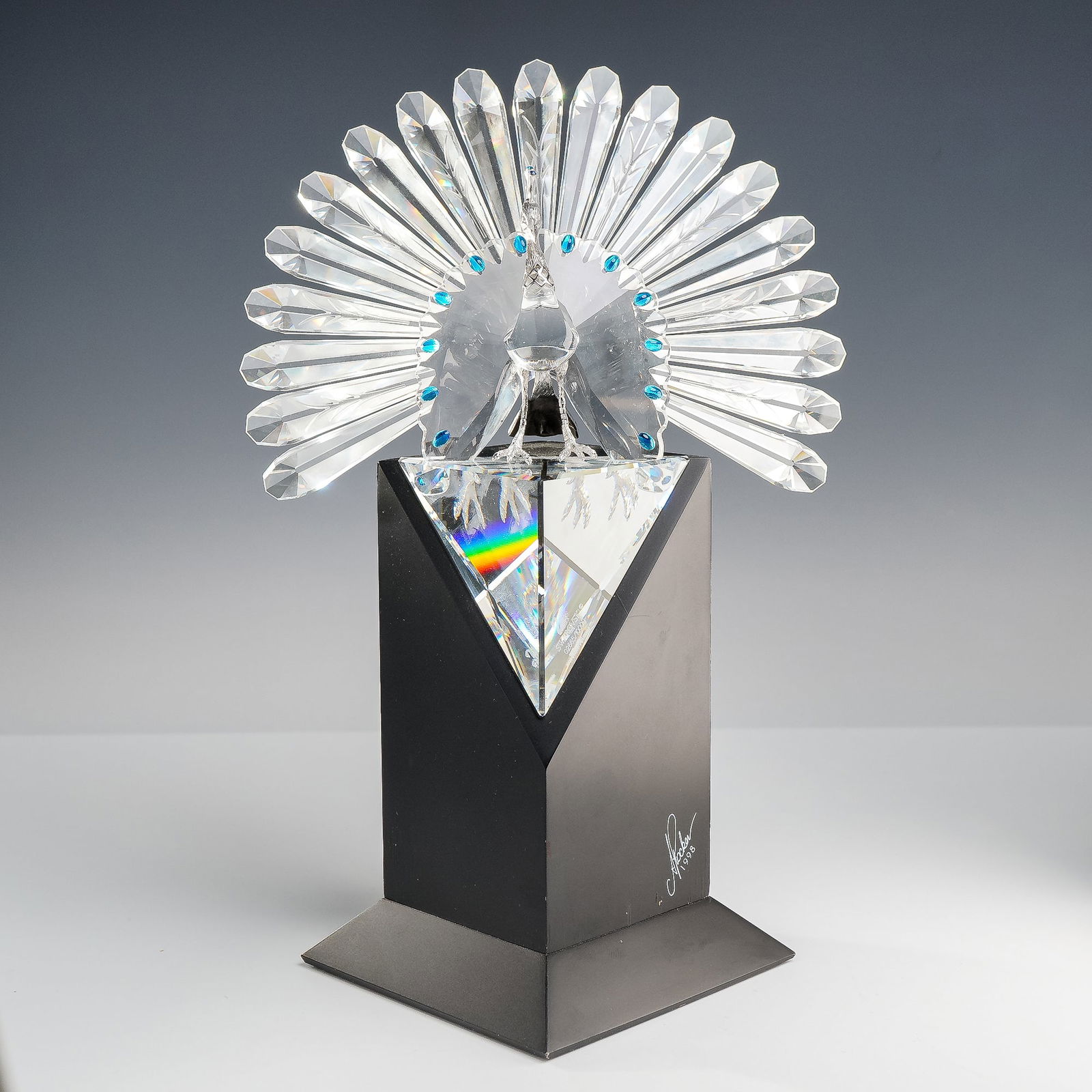 Swarovski Crystal Signed Limited Edition Figurine Peacock 218123: A Swarovski Silver Crystal limited edition figurine titled "The Peacock" (model 218123), designed by Adi Stocker and released in 1998. This majestic piece features a multi-faceted clear lead crystal b