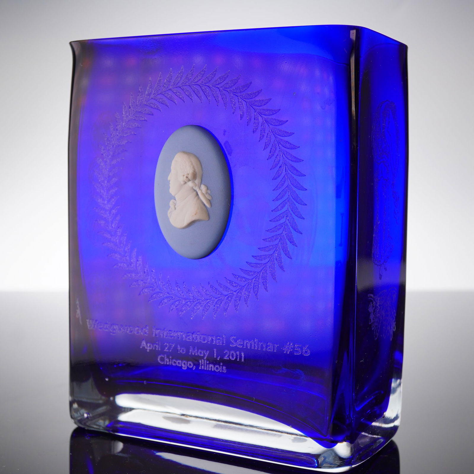 2011 Wedgwood International Seminar Commemorative Cobalt Blue Glass Vessel: A single, contemporary, rectangular commemorative vessel crafted from heavy, solid cobalt blue glass. The piece features a thick, hand-blown construction, as indicated by the base sticker. The front f
