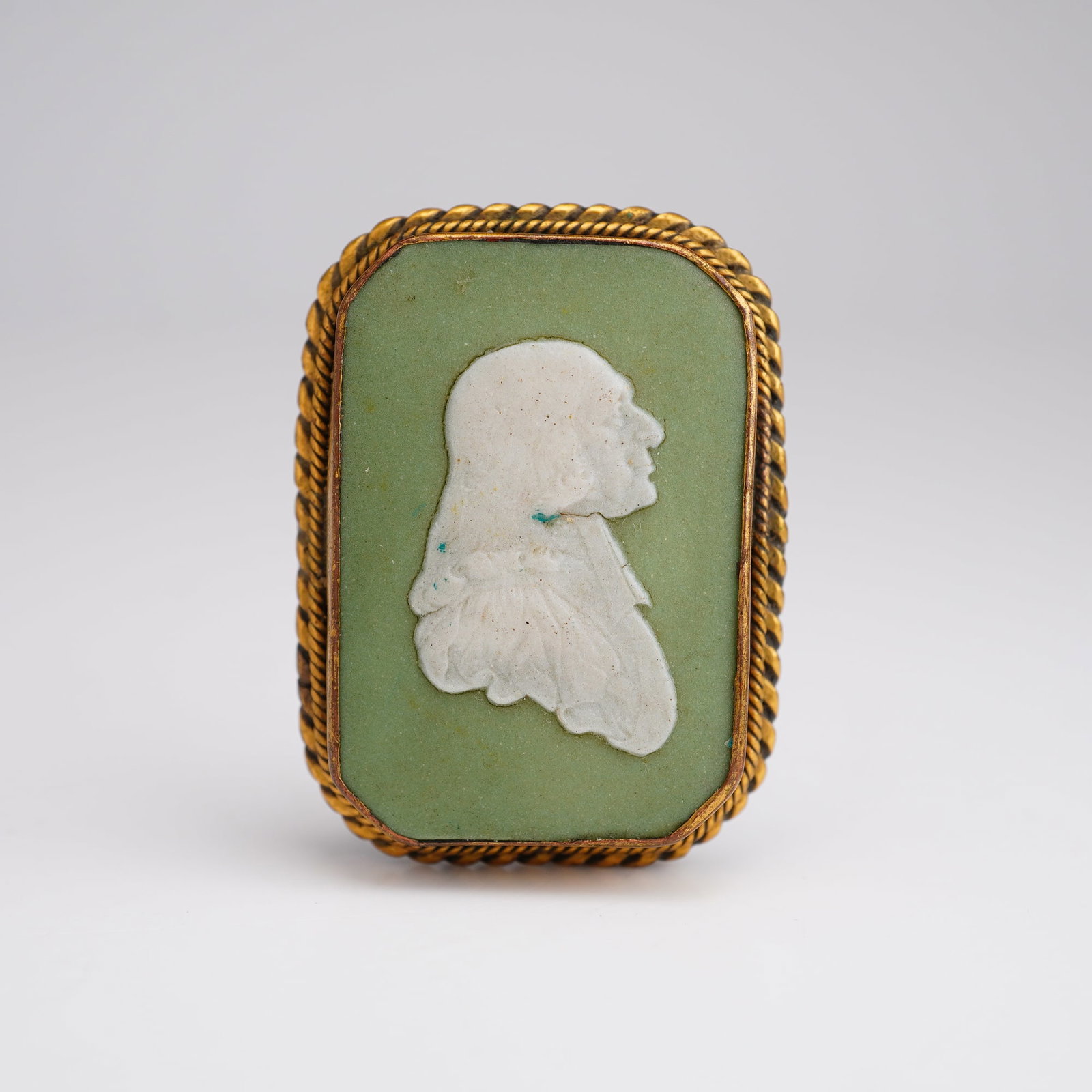 Wedgwood Green and White Jasperware Brooch Top of John Wesley: A small green and white cut-cornered Jasperware portrait brooch top depicting John Wesley (English, 1703-1791), shown in right-facing profile. The brooch is mounted in a gilt-metal frame with a twiste