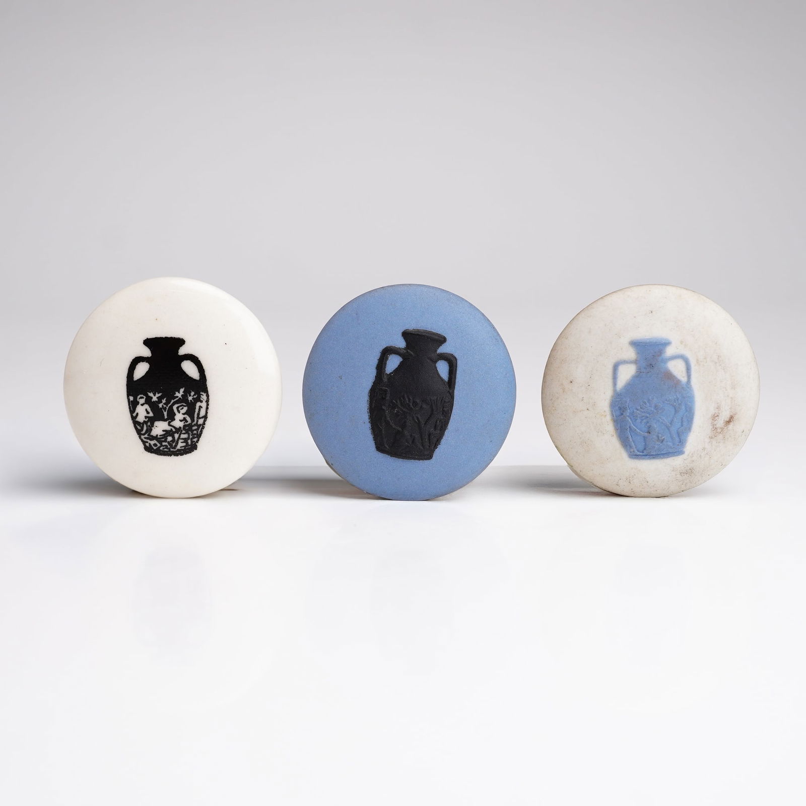 3pc Wedgwood Jasperware and Acrylic Seminar Buttons: The collection includes two Jasperware examples in blue-and-black, and white-and-blue color variation, and one black-and-white acrylic example. Each button features a depiction of the Portland Vase. T
