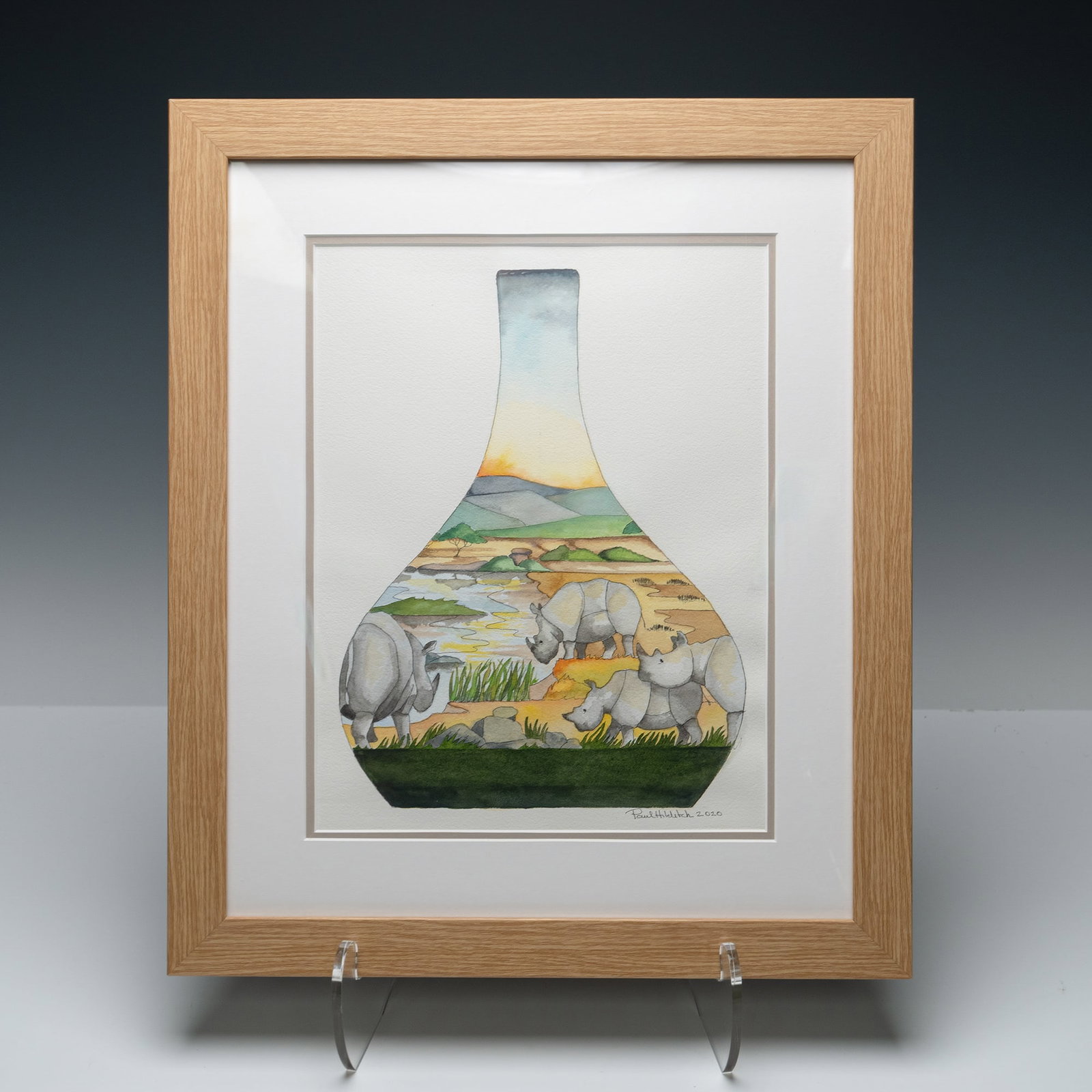 Moorcroft Framed Watercolor Painting by Paul Hilditch African Rhinos: Framed watercolor painting by Paul Hilditch, dated 2020, depicting a herd of African rhinos in a serene natural habitat. The composition is uniquely contained within the shape of a Moorcroft-style bot