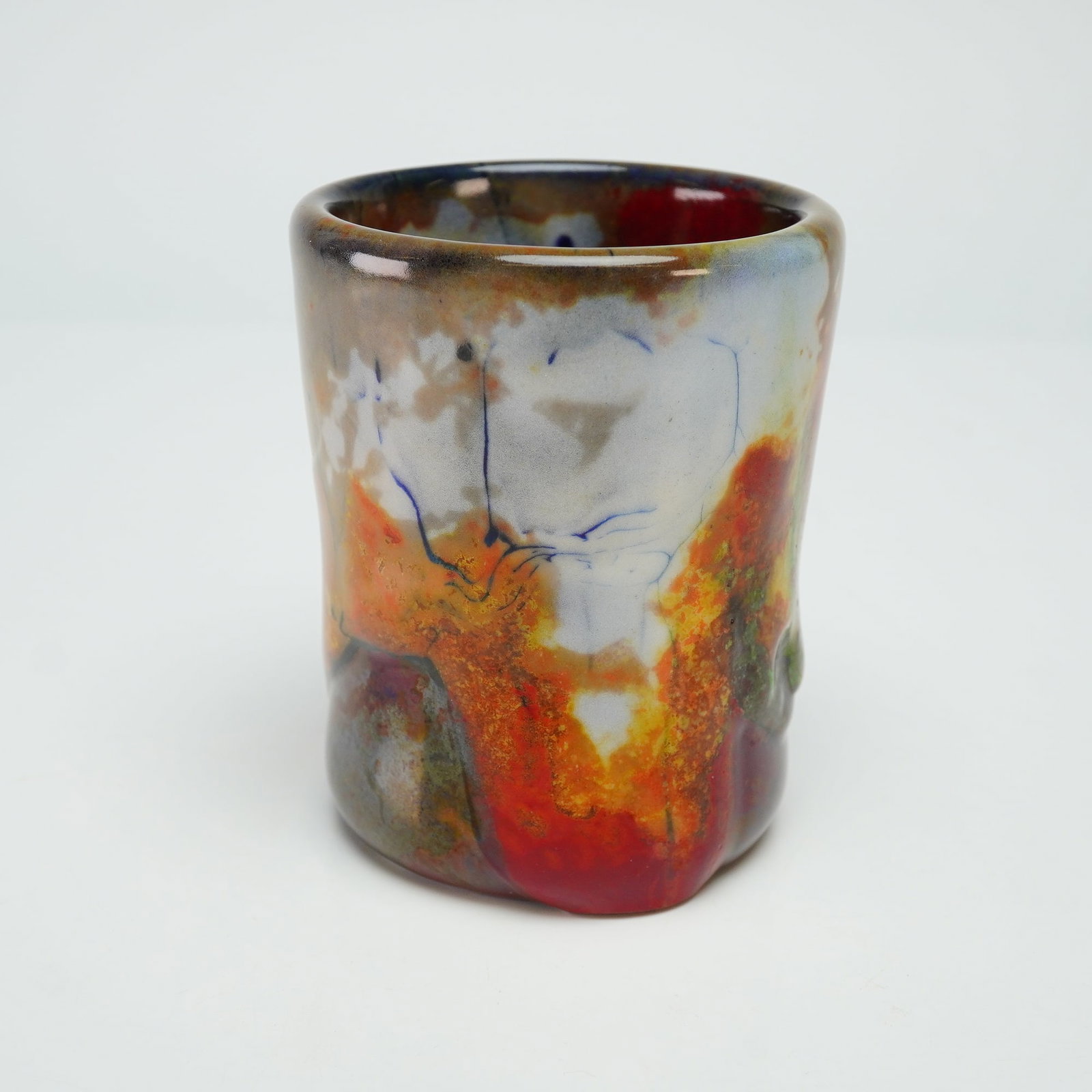 Royal Doulton by Charles Noke and Harry Nixon Chang Flambe Pot: Featuring a copper-enriched reduction glaze fired at high temperatures, this piece displays a vibrant array of streaked colors, ranging from deep reds and oxbloods to purples, browns, oranges, with oc
