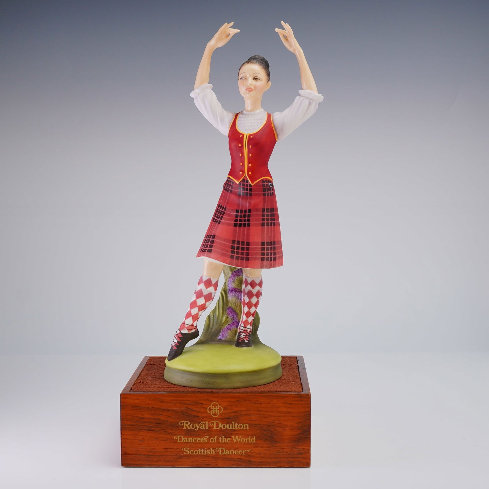 Royal Doulton Limited Edition Scottish Highland Dancer HN2436: A Royal Doulton Limited Edition (181/750) Bone China Figurine, Scottish Dancer (HN2436), modeled by Peggy Davies, presented on a wooden stand measuring 4.75"W x 2"H, accompanied by its original box an