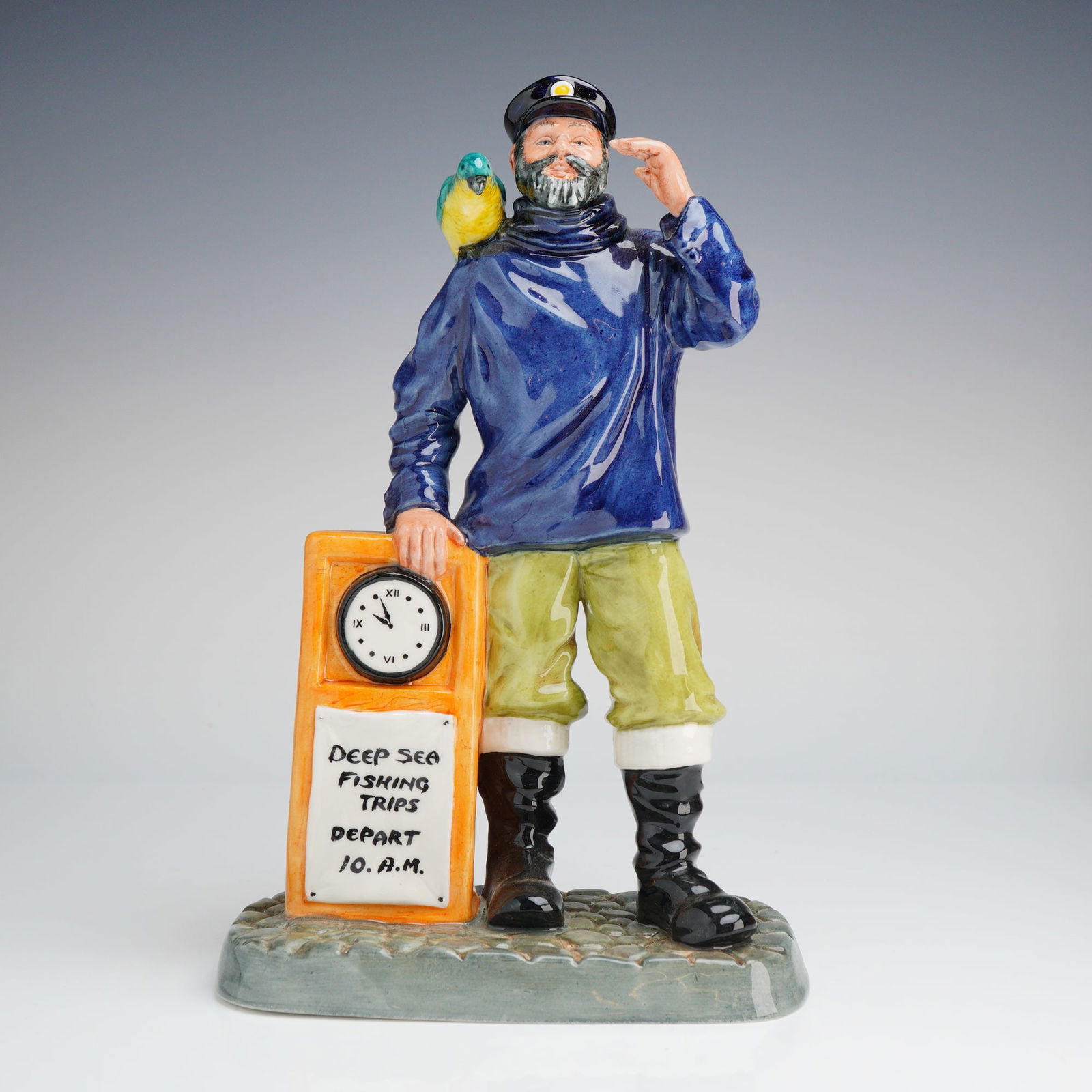 Royal Doulton All Aboard HN 2940 Porcelain Figurine: A single Royal Doulton Figurine, All Aboard (HN2940), dated 1981, depicting a sea captain with a parrot next to an orange kiosk advertising deep sea fishing trips. Dimensions5.75"L x 3.25"W x 9.50"H W
