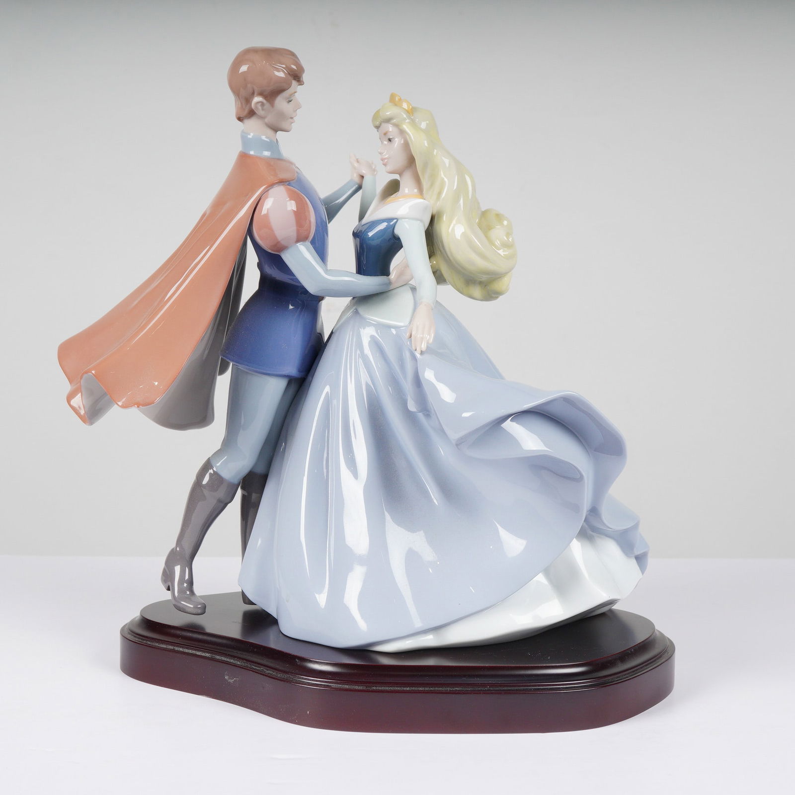 Lladro Sleeping Beauty Lladro Figurine 1007560: This is a fine glazed porcelain figurine by Lladro titled Sleeping Beauty, model number 7560 (1007560), depicting Princess Aurora and Prince Phillip in a dancing pose. This piece was created as a limi
